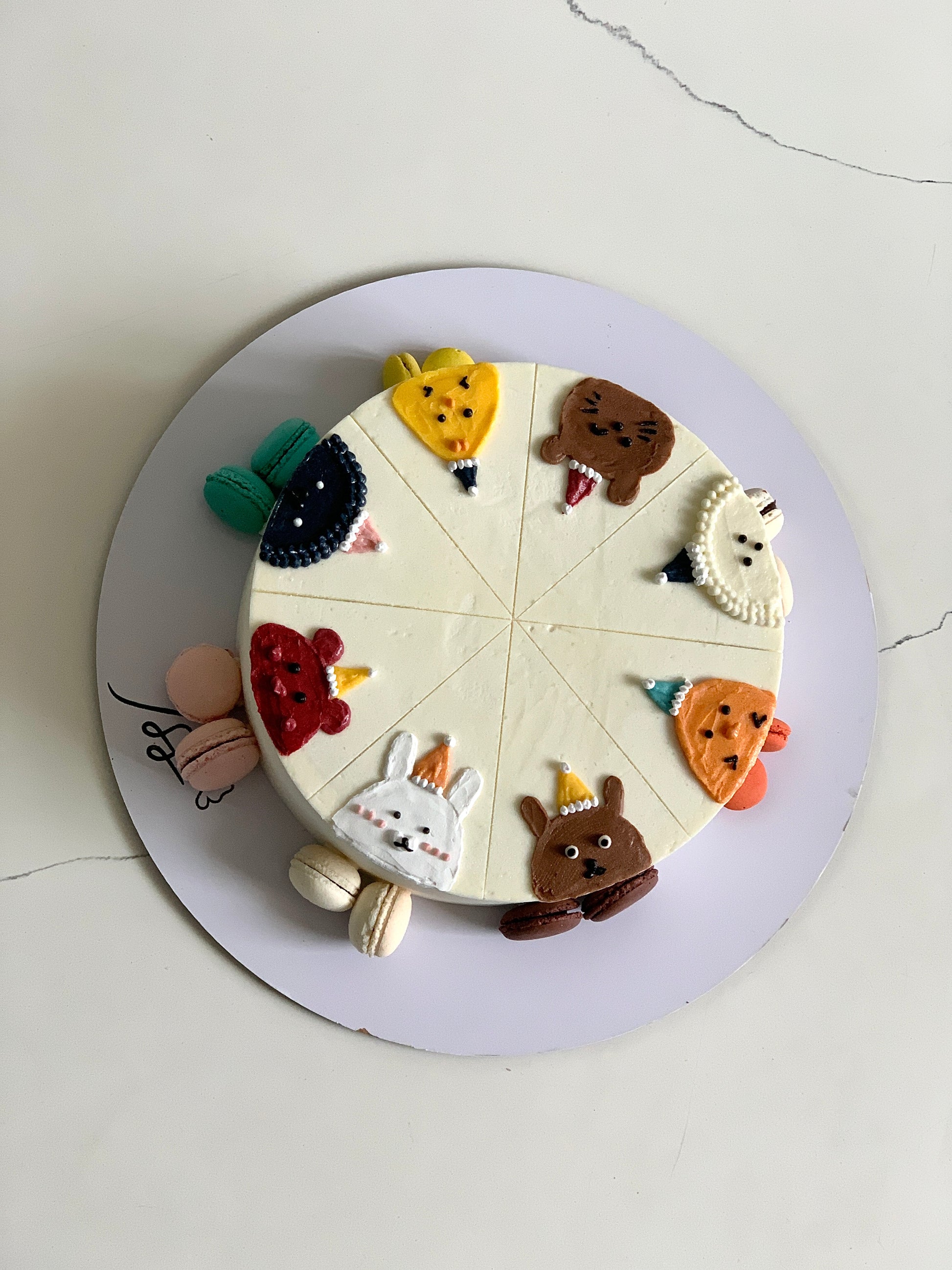 Decorative buttercream illustration cake by The Sinful Spoon featuring colorful floral and whimsical designs on a layered cake.