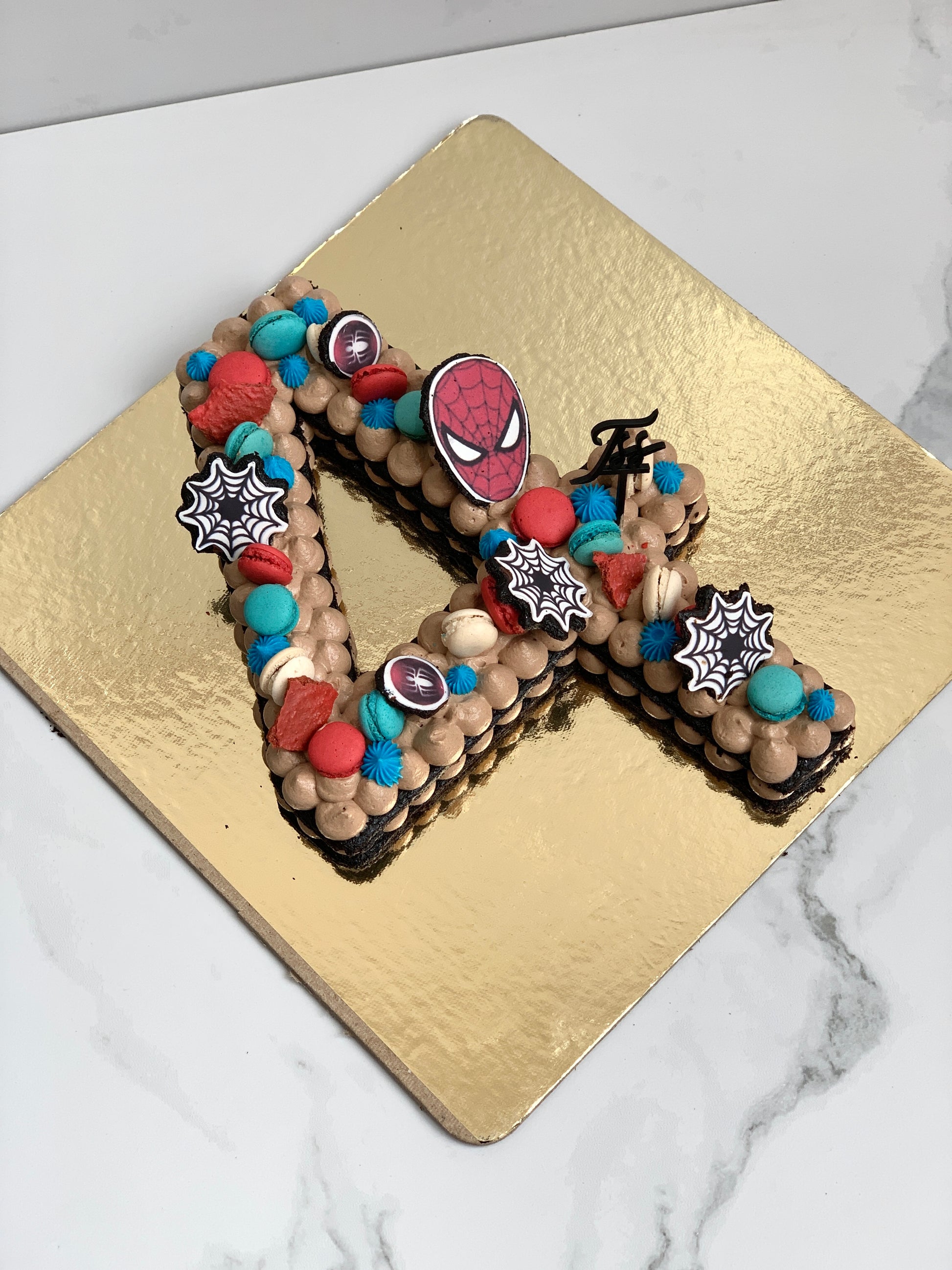 Decorative cookie cakes from The Sinful Spoon, featuring colorful frosting and festive design details.