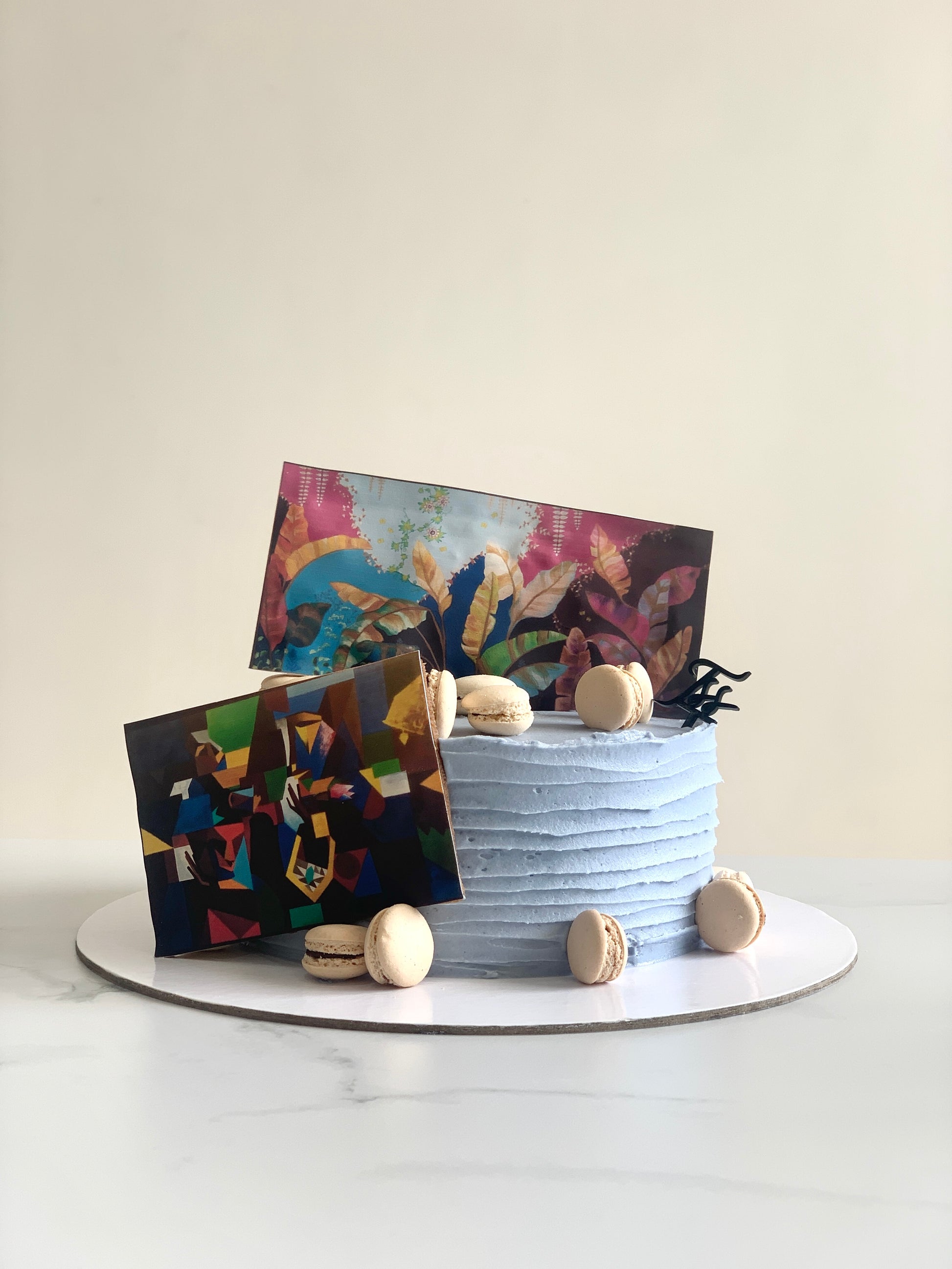 Edible paper cake decorated with colorful floral designs, created by The Sinful Spoon for a festive celebration.
