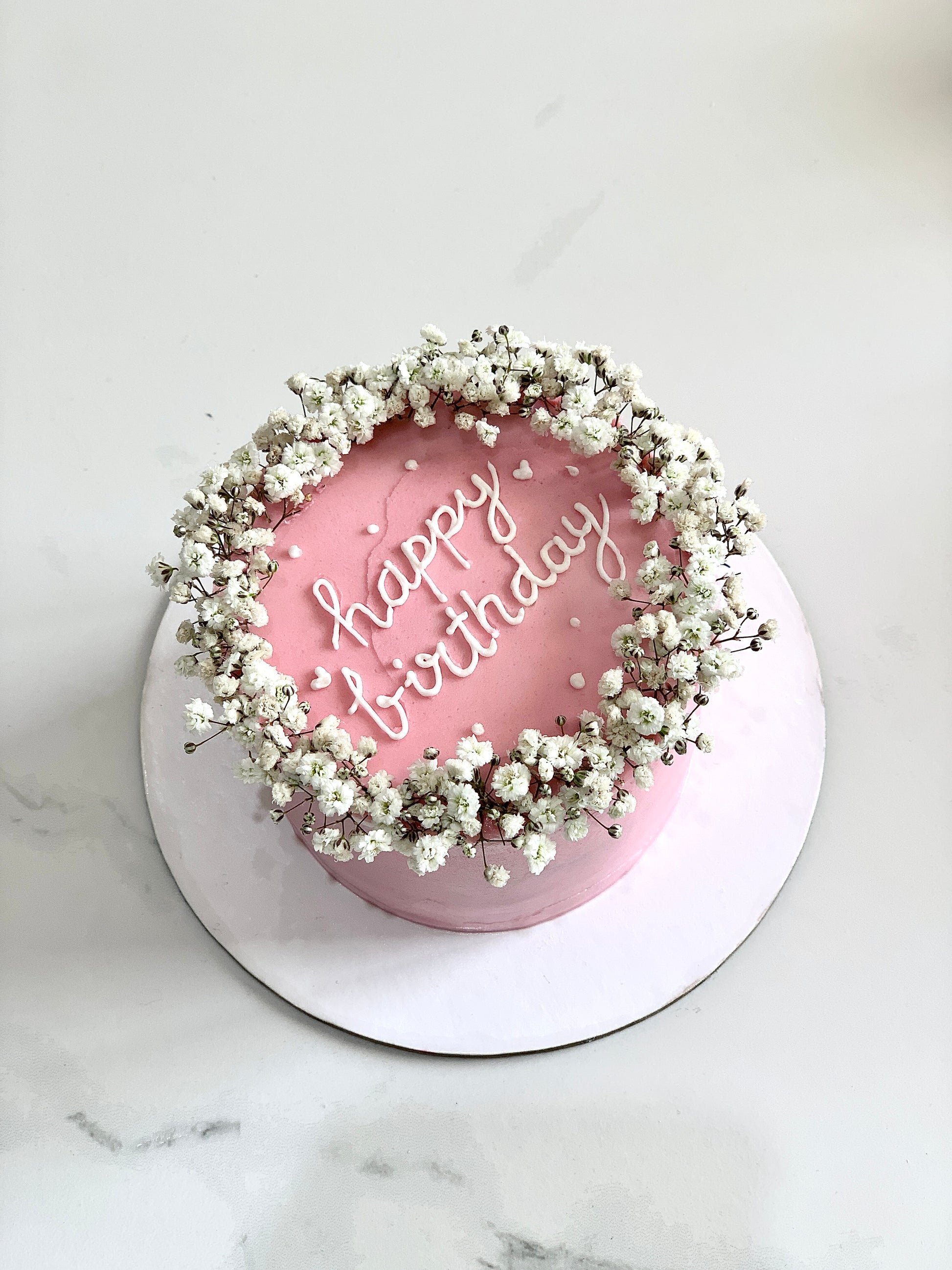 Decorative Mother's Day cake from The Sinful Spoon with floral frosting and elegant design, perfect for celebrating moms.