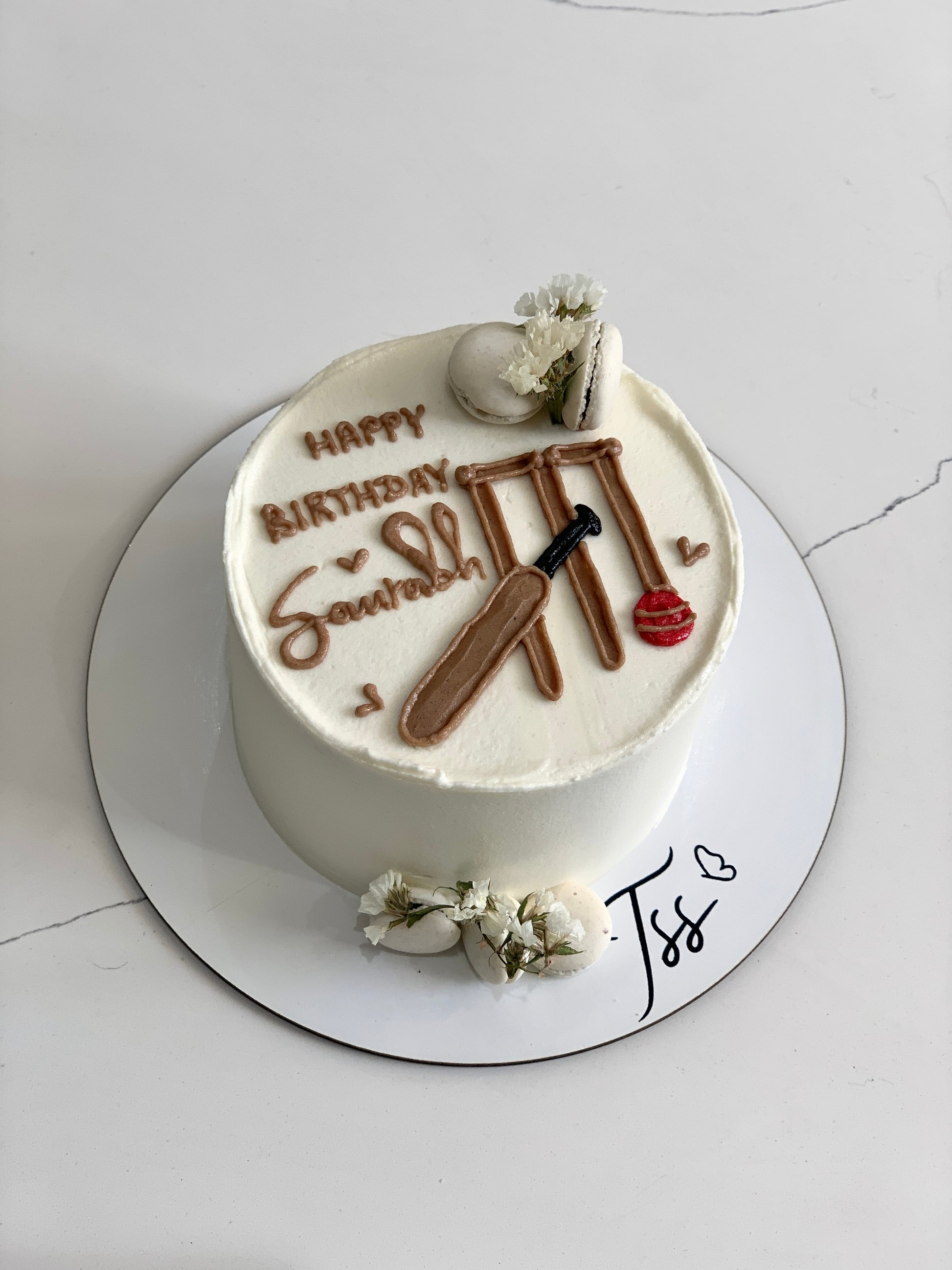 Decorative buttercream illustration cake by The Sinful Spoon featuring intricate floral and artistic designs on a layered cake.