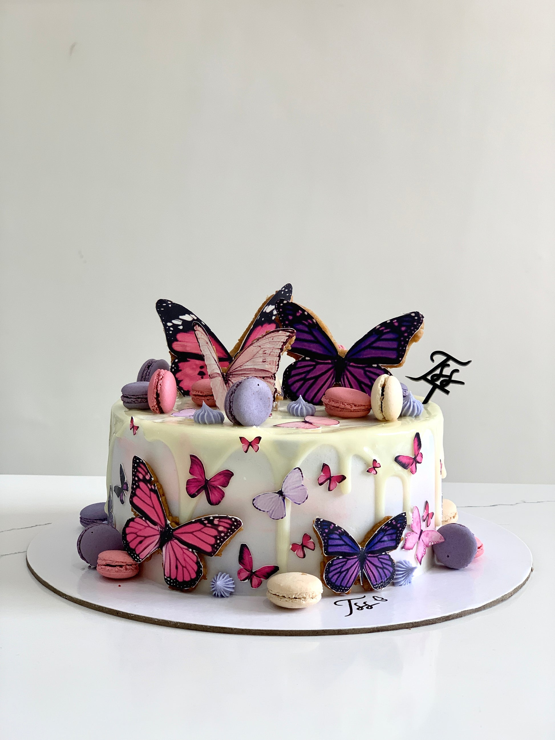 Edible paper cake featuring a baby girl design from The Sinful Spoon, decorated with pastel colors and intricate edible details.