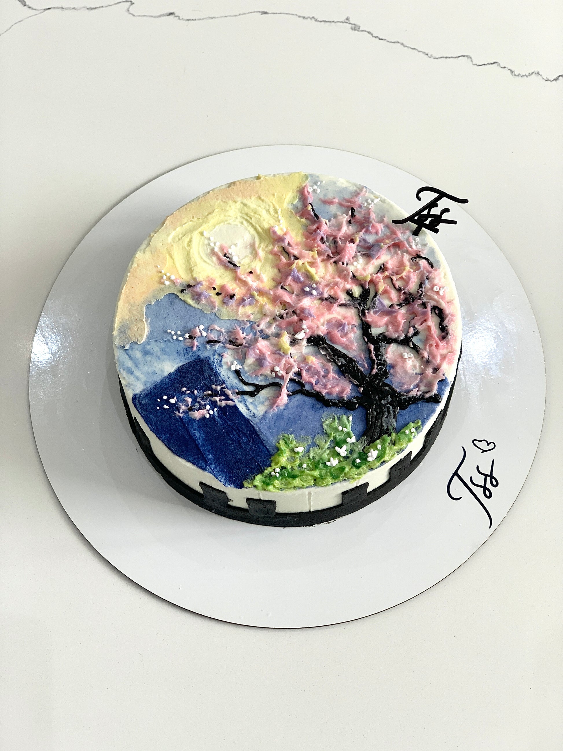 Colorful buttercream illustration cake with floral and whimsical designs by The Sinful Spoon, topped with vibrant edible decorations.
