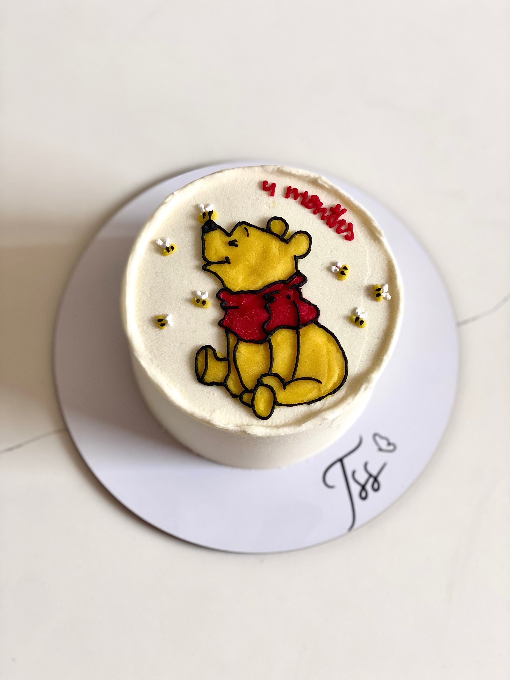 Buttercream illustration cake by The Sinful Spoon featuring colorful, detailed floral and whimsical designs on a tiered cake.
