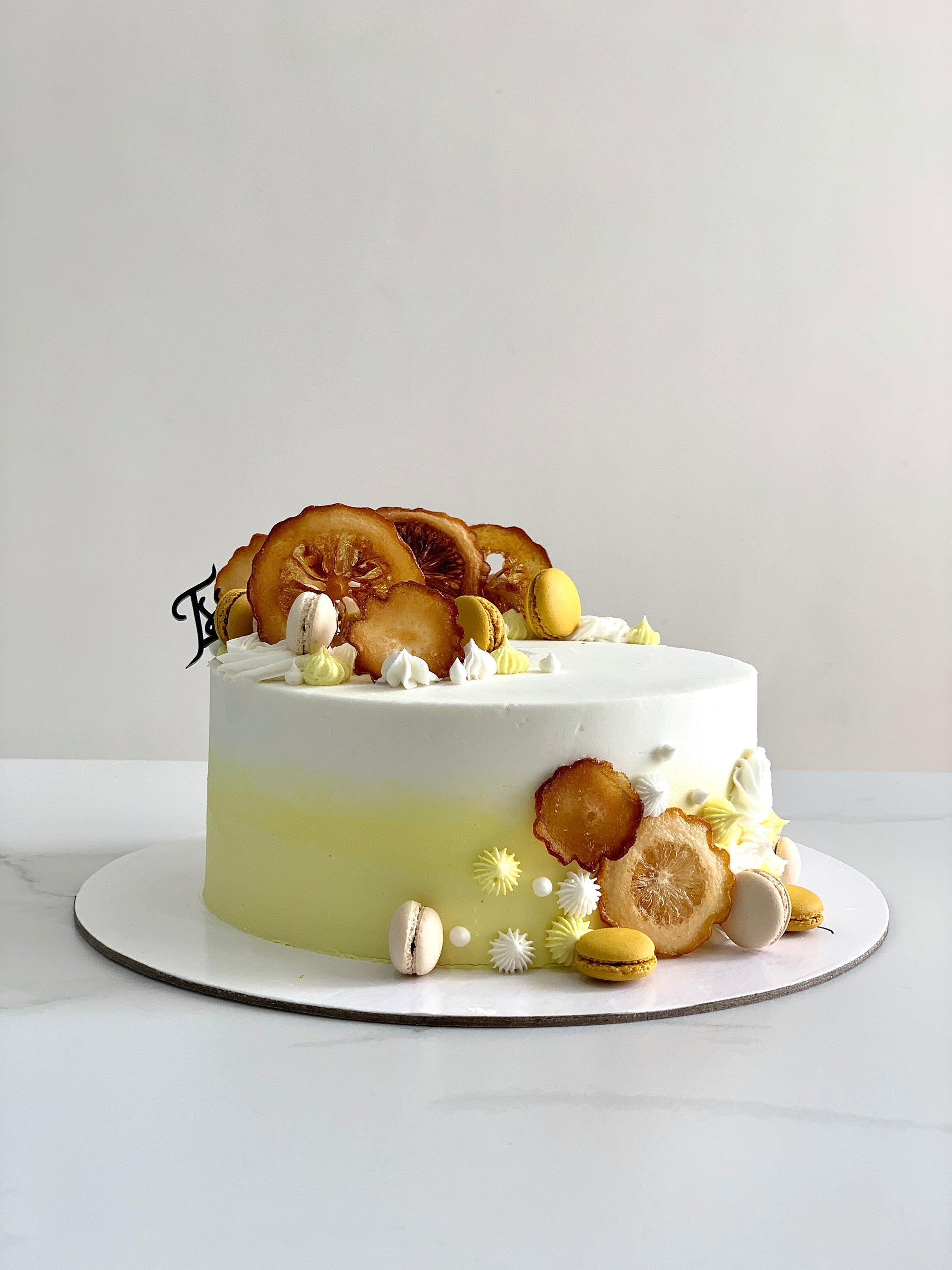 Fresh fruit cakes from The Sinful Spoon with colorful fruit toppings and moist cake layers, displayed on a plate.