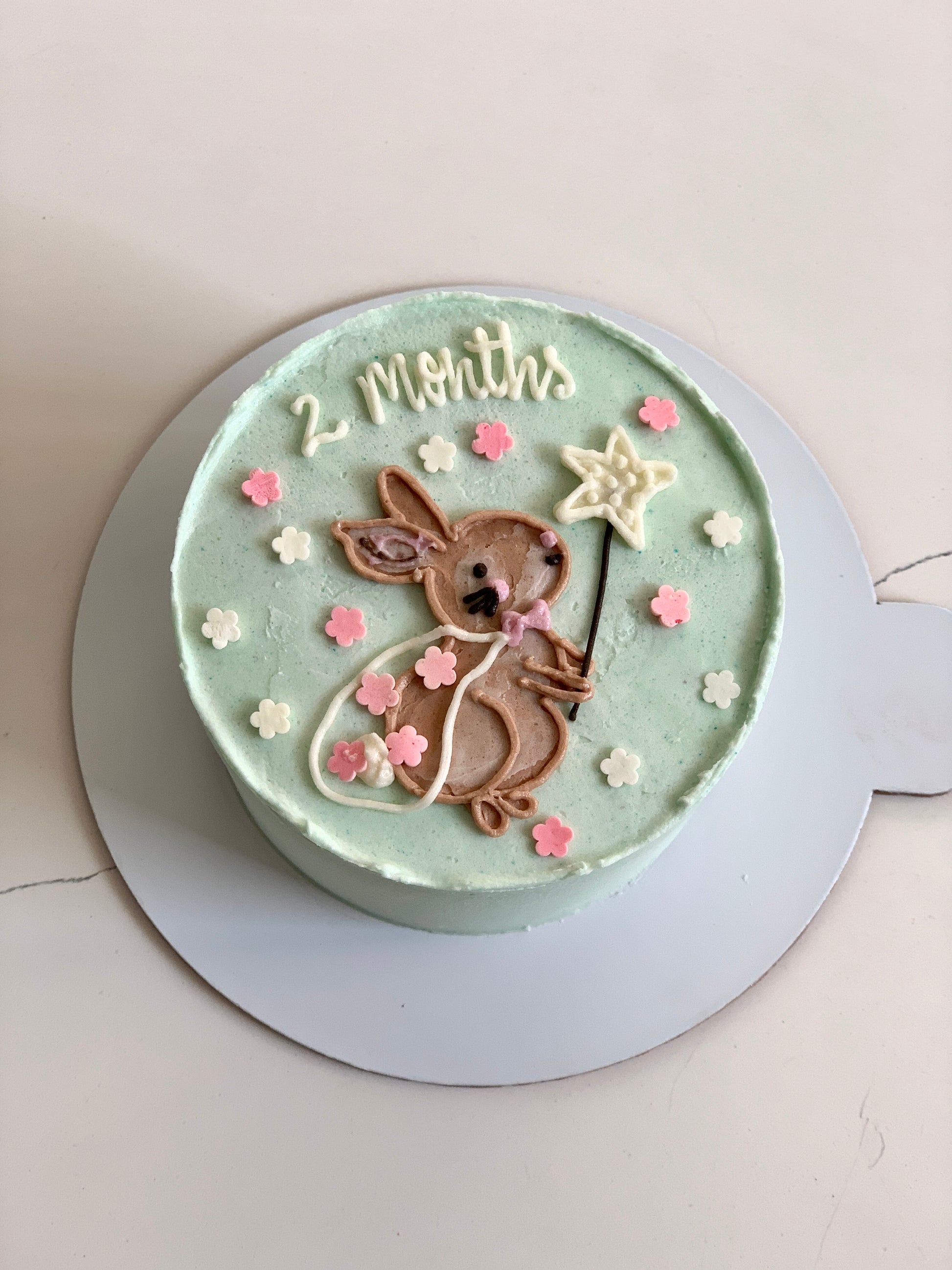 Decorative buttercream illustration cake by The Sinful Spoon featuring colorful floral and artistic piping details.