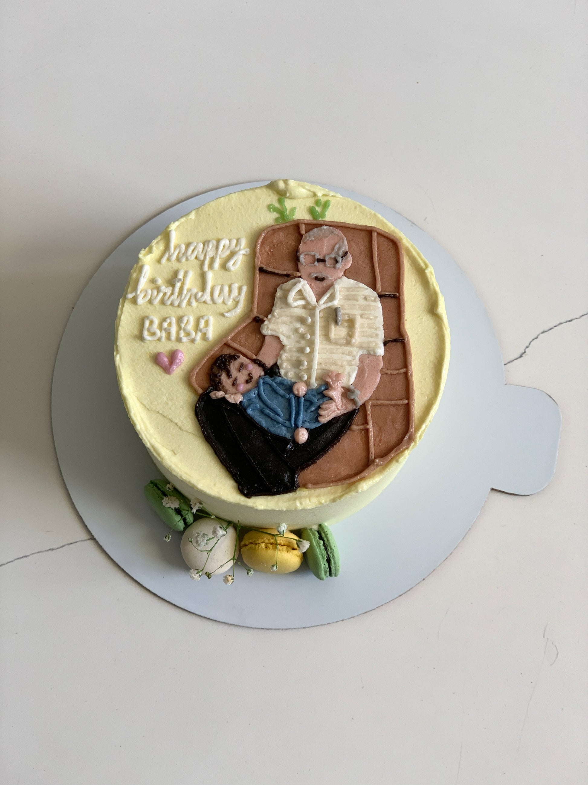 Decorative buttercream illustration cake from The Sinful Spoon with colorful floral and whimsical designs on smooth white icing.