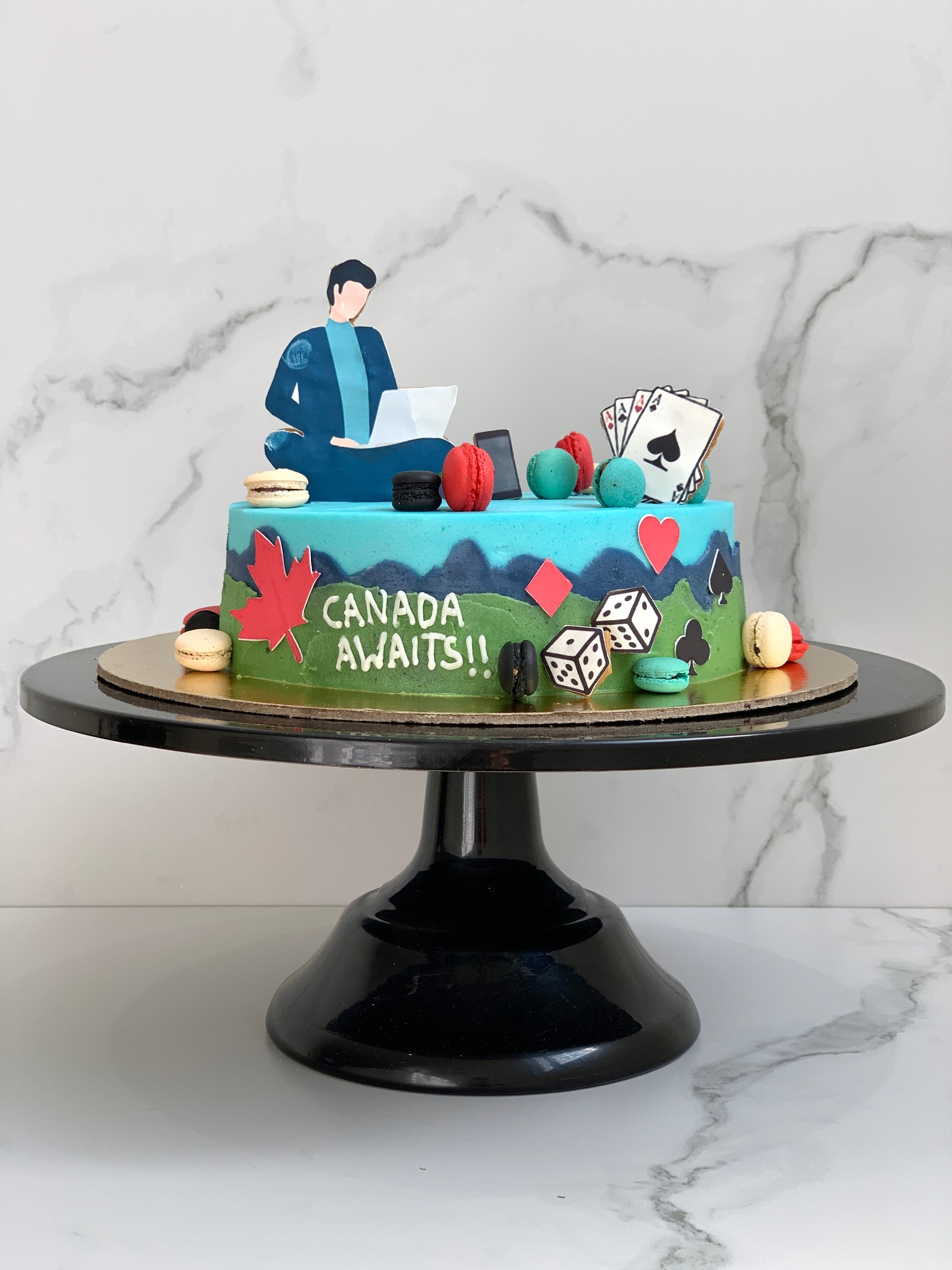 Edible paper cakes from The Sinful Spoon featuring colorful decorative designs on a layered cake.