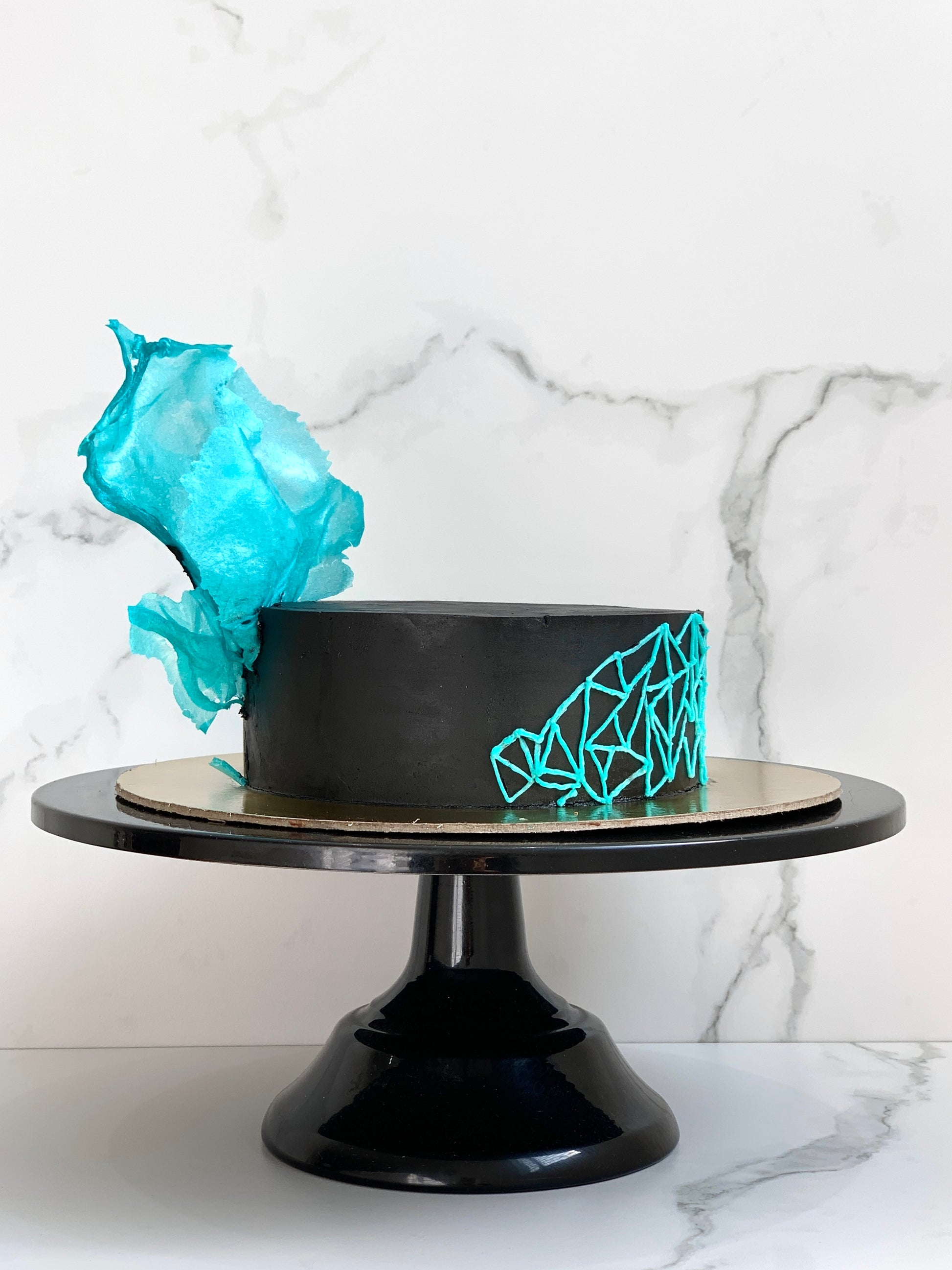 Slice of Classic Cakes from The Sinful Spoon showcasing layered cake with chocolate and vanilla frosting on a serving plate.