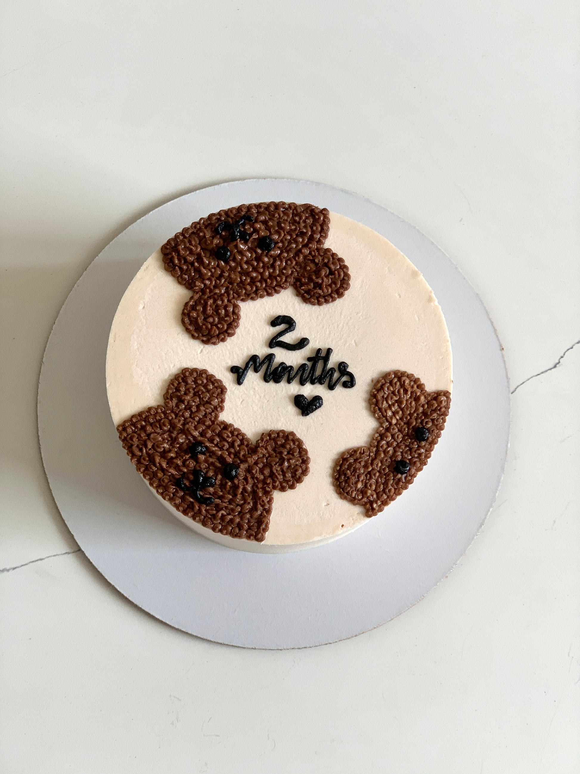 Decorative buttercream illustration cake by The Sinful Spoon featuring intricate colorful floral designs on smooth buttercream.