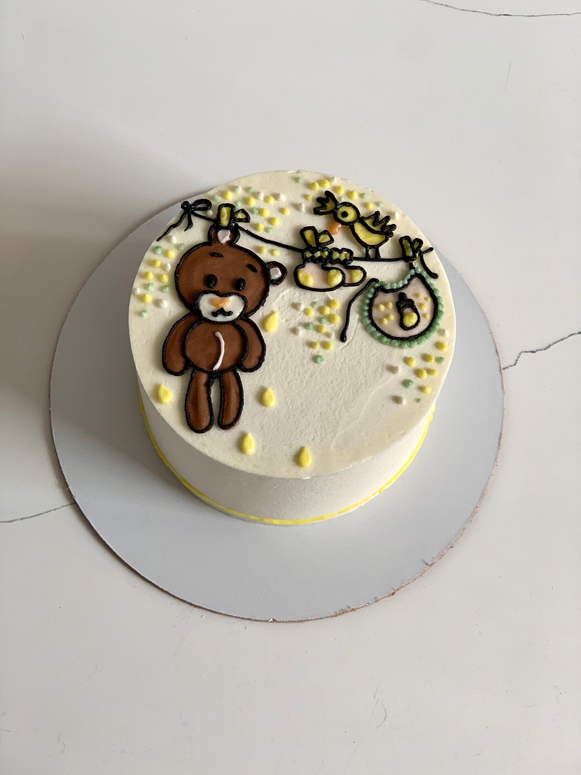 Colorful buttercream illustration cake by The Sinful Spoon with vibrant floral and decorative piping design.