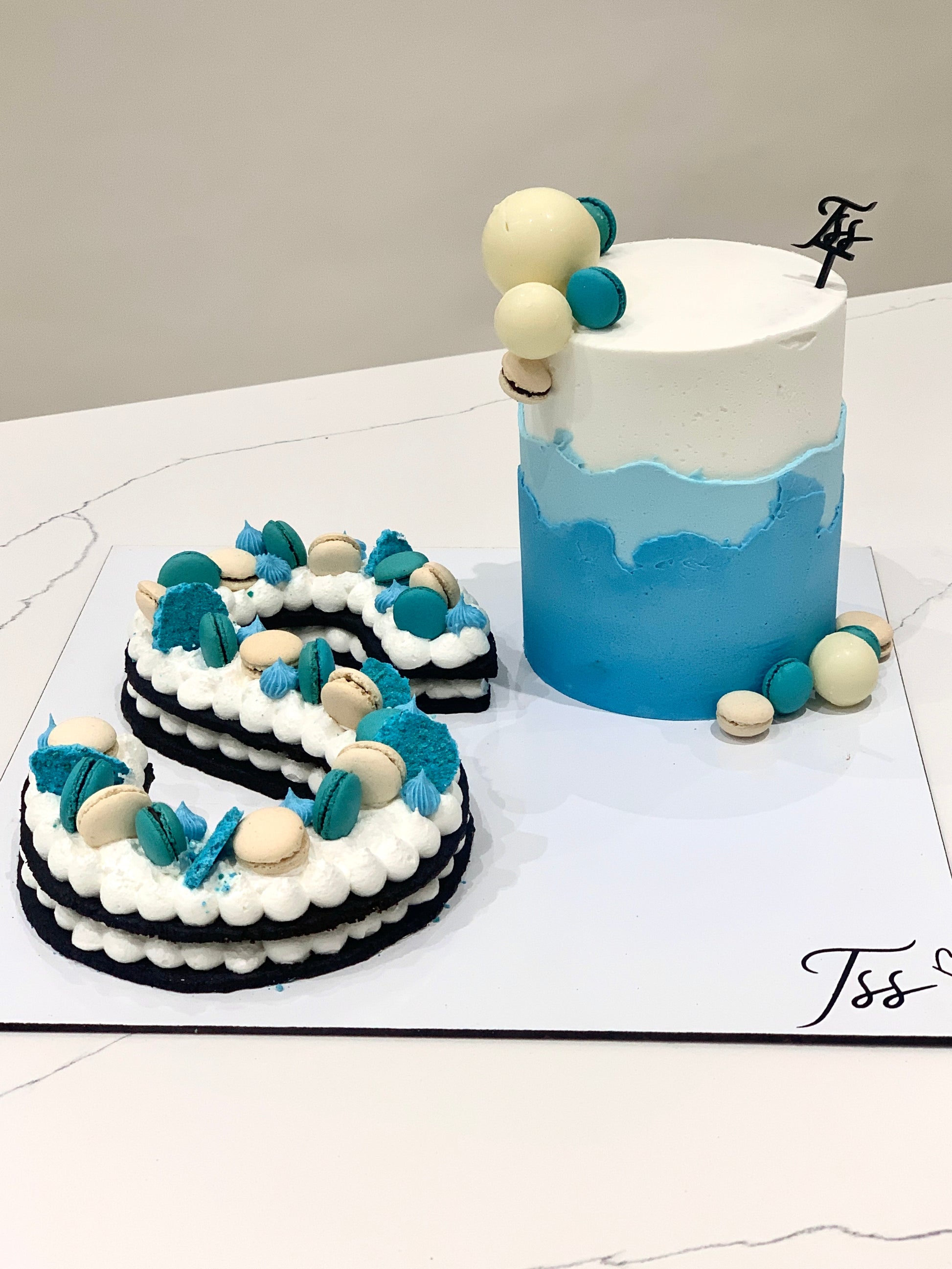 Assorted combo cakes from The Sinful Spoon displayed on a plate, featuring various flavors and colorful frosting details.