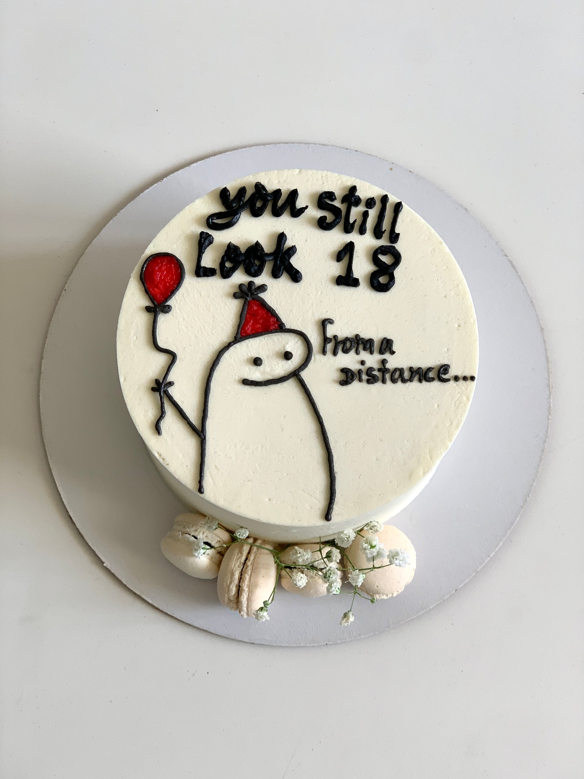 Decorative buttercream illustration cake by The Sinful Spoon featuring colorful floral and whimsical design details.