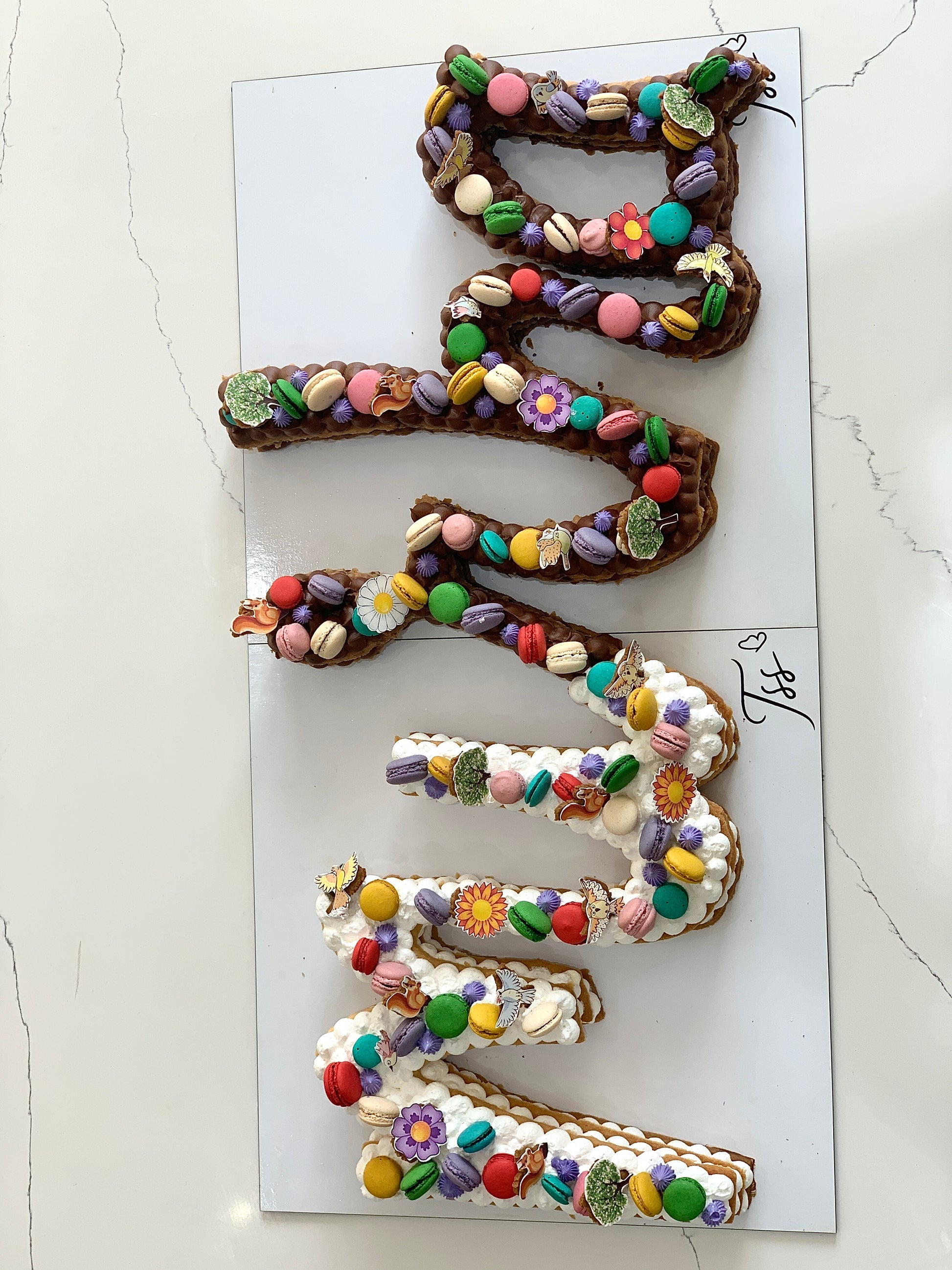 Chocolate cookie cakes from The Sinful Spoon, topped with colorful sprinkles and decorated with frosting.