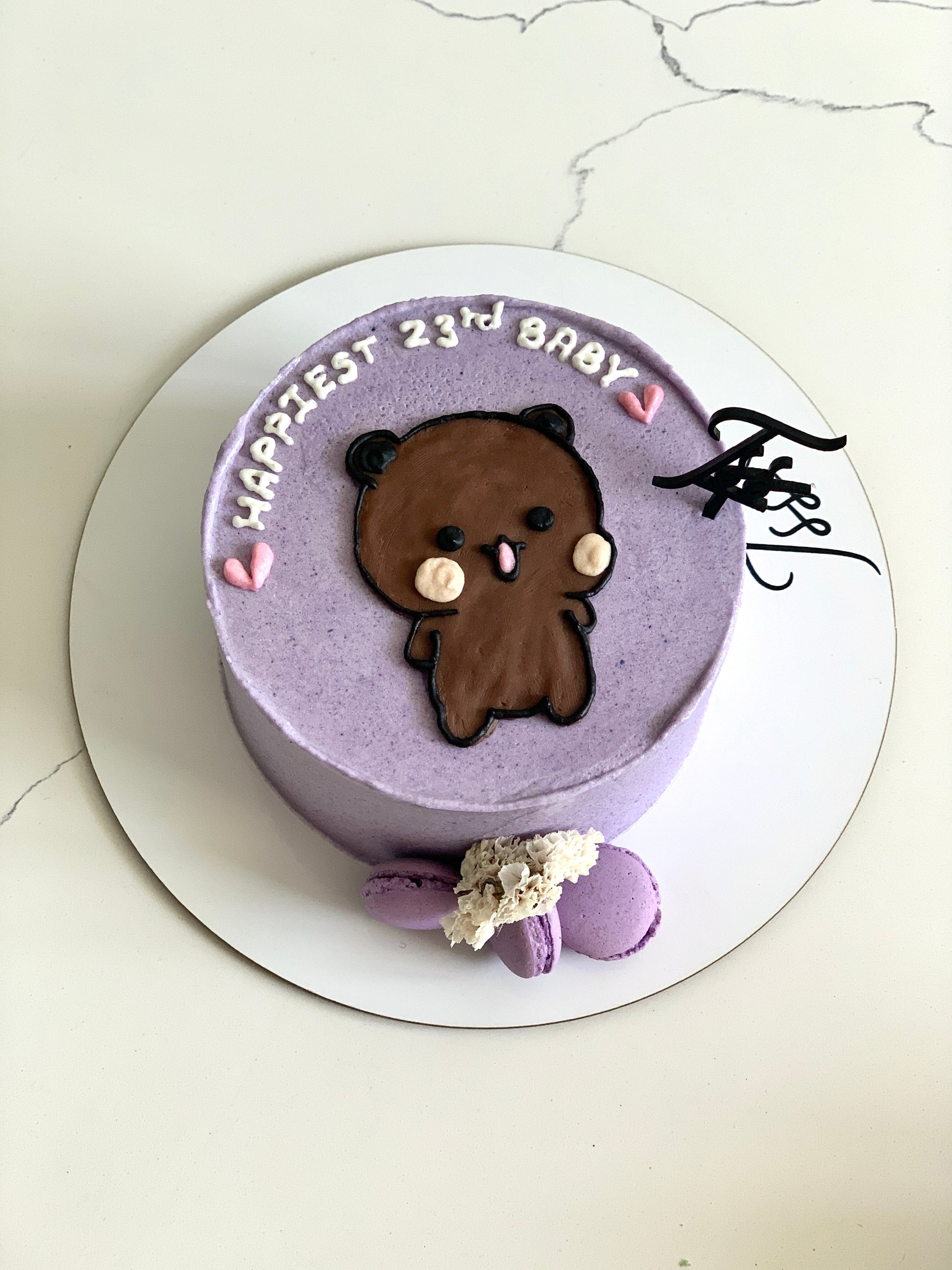 Decorative buttercream illustration cake by The Sinful Spoon featuring colorful floral and whimsical designs on smooth buttercream surface.