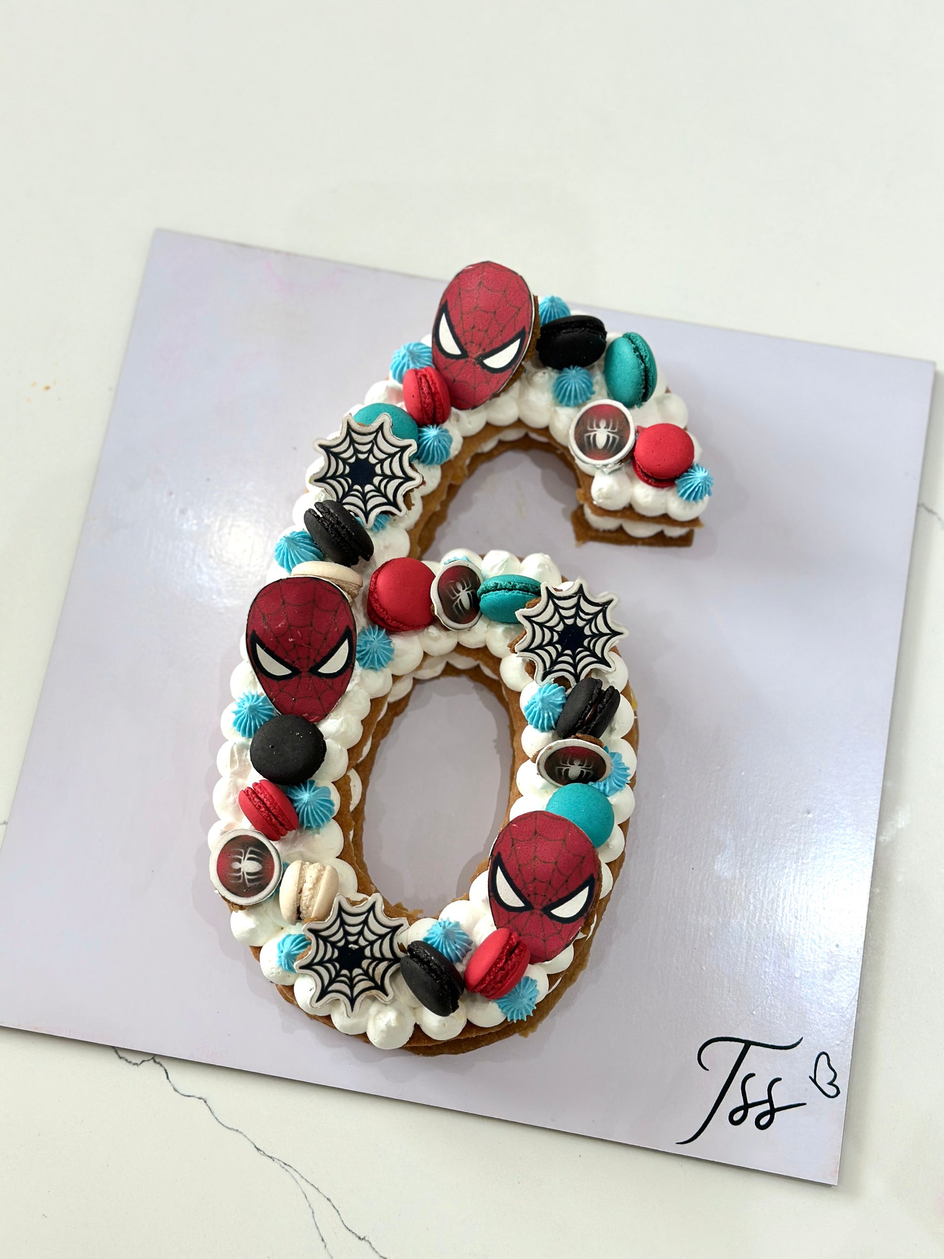 Chocolate chip cookie cake from The Sinful Spoon with colorful sprinkles on top, showcasing a large, round dessert.