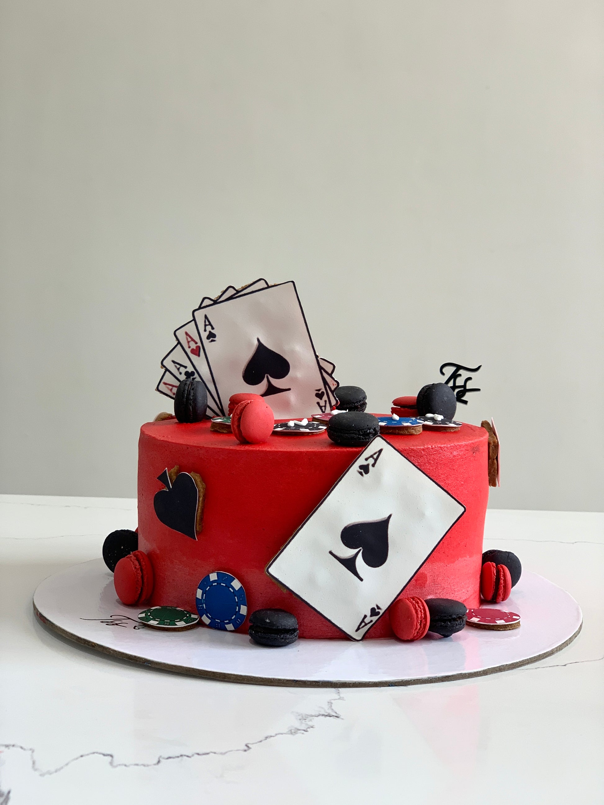 Decorative festive cakes from The Sinful Spoon with colorful icing and holiday-themed designs on a white platter.