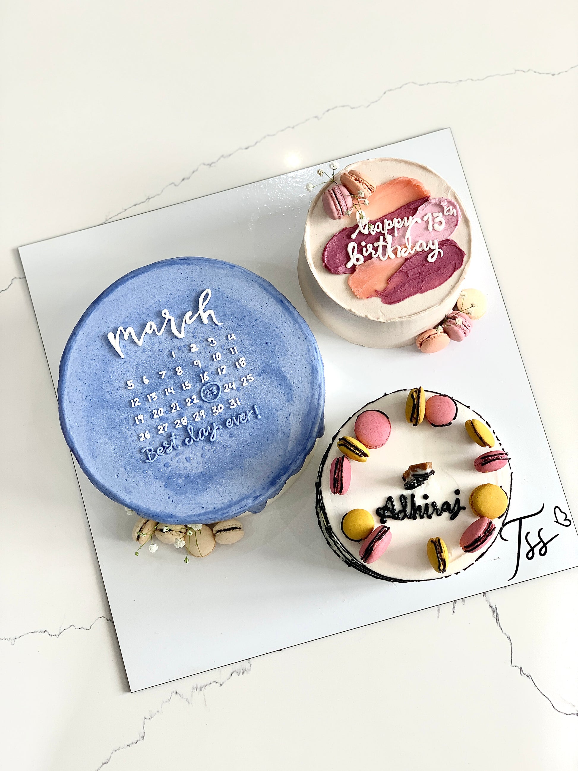 Assorted combo cakes from The Sinful Spoon, featuring layered and decorated desserts displayed on a tray.