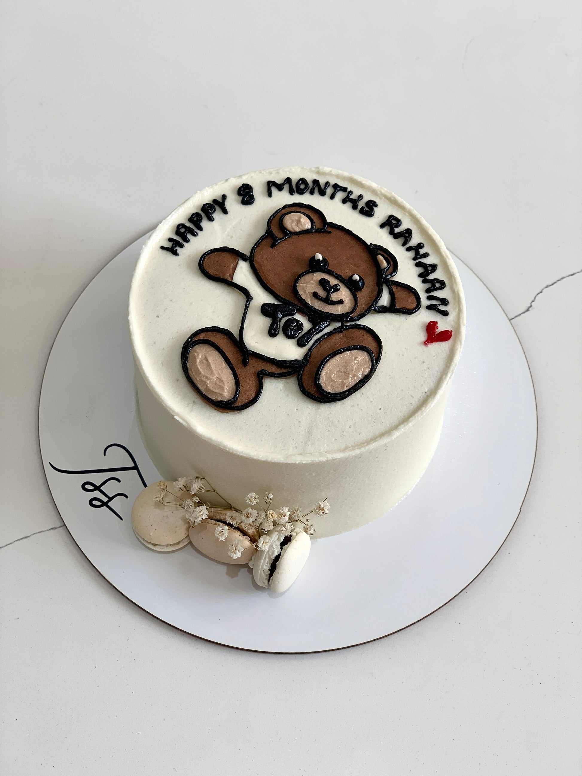 Decorative buttercream illustration cake by The Sinful Spoon with colorful floral and whimsical designs on smooth icing.