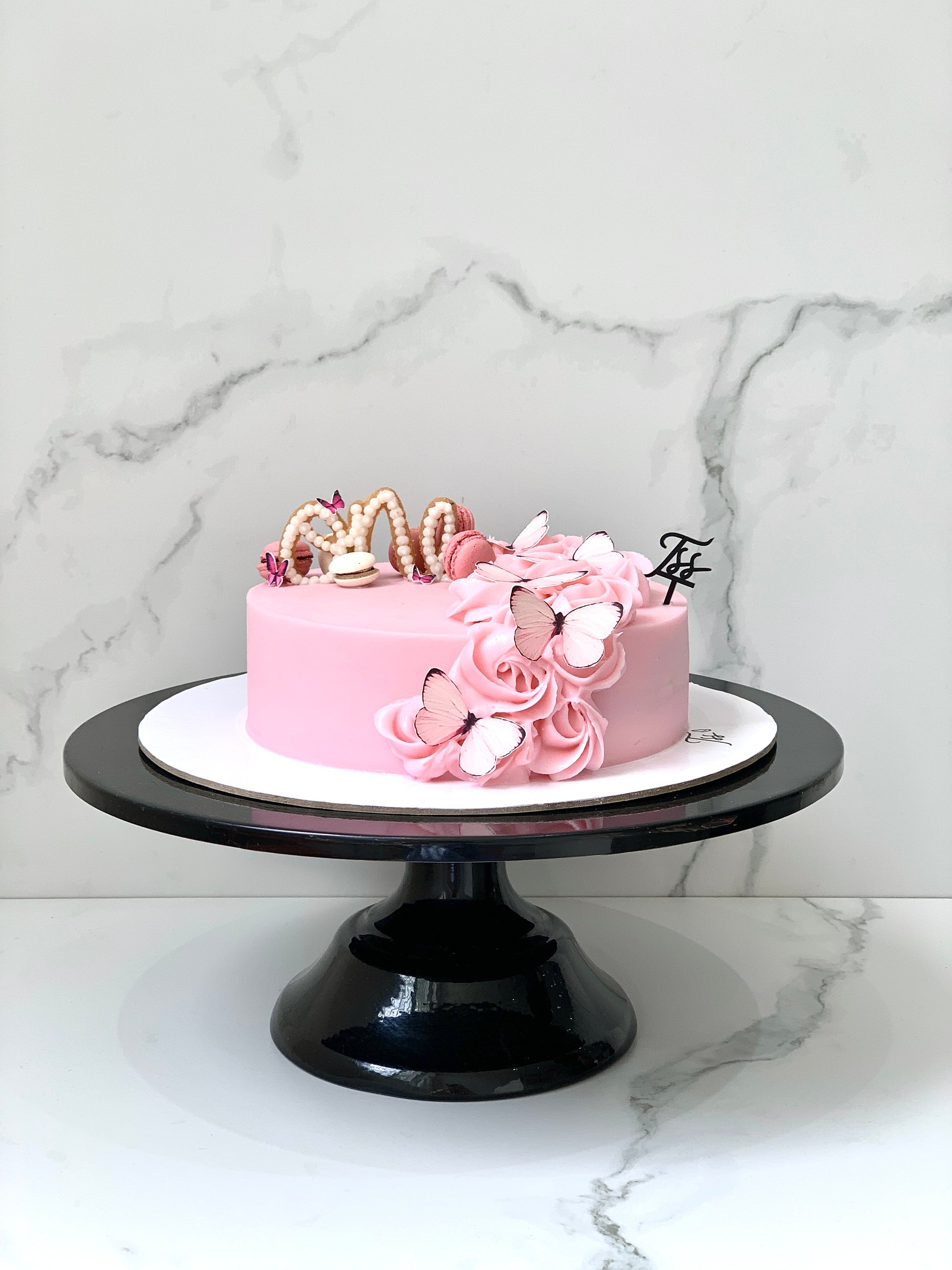 Edible paper cake decorated for a baby girl celebration, featuring colorful baby-themed designs by The Sinful Spoon.