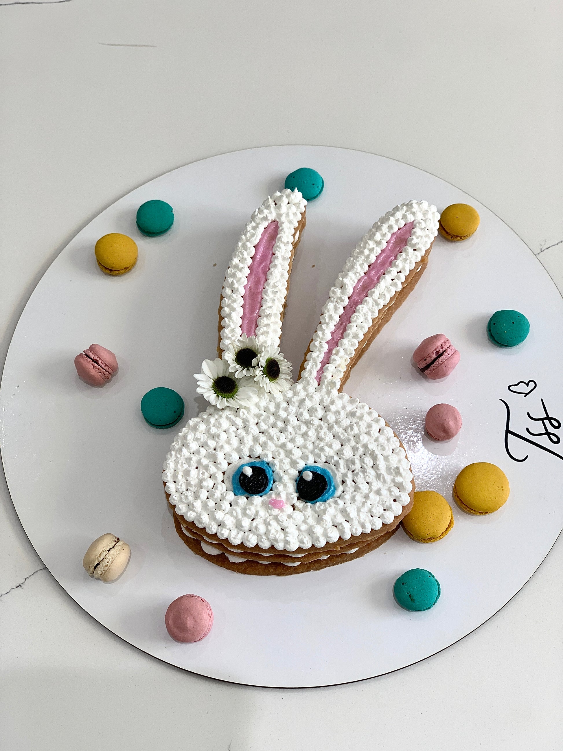 Chocolate chip cookie cake from The Sinful Spoon with a decorated frosting top and colorful sprinkles, ready for celebration.