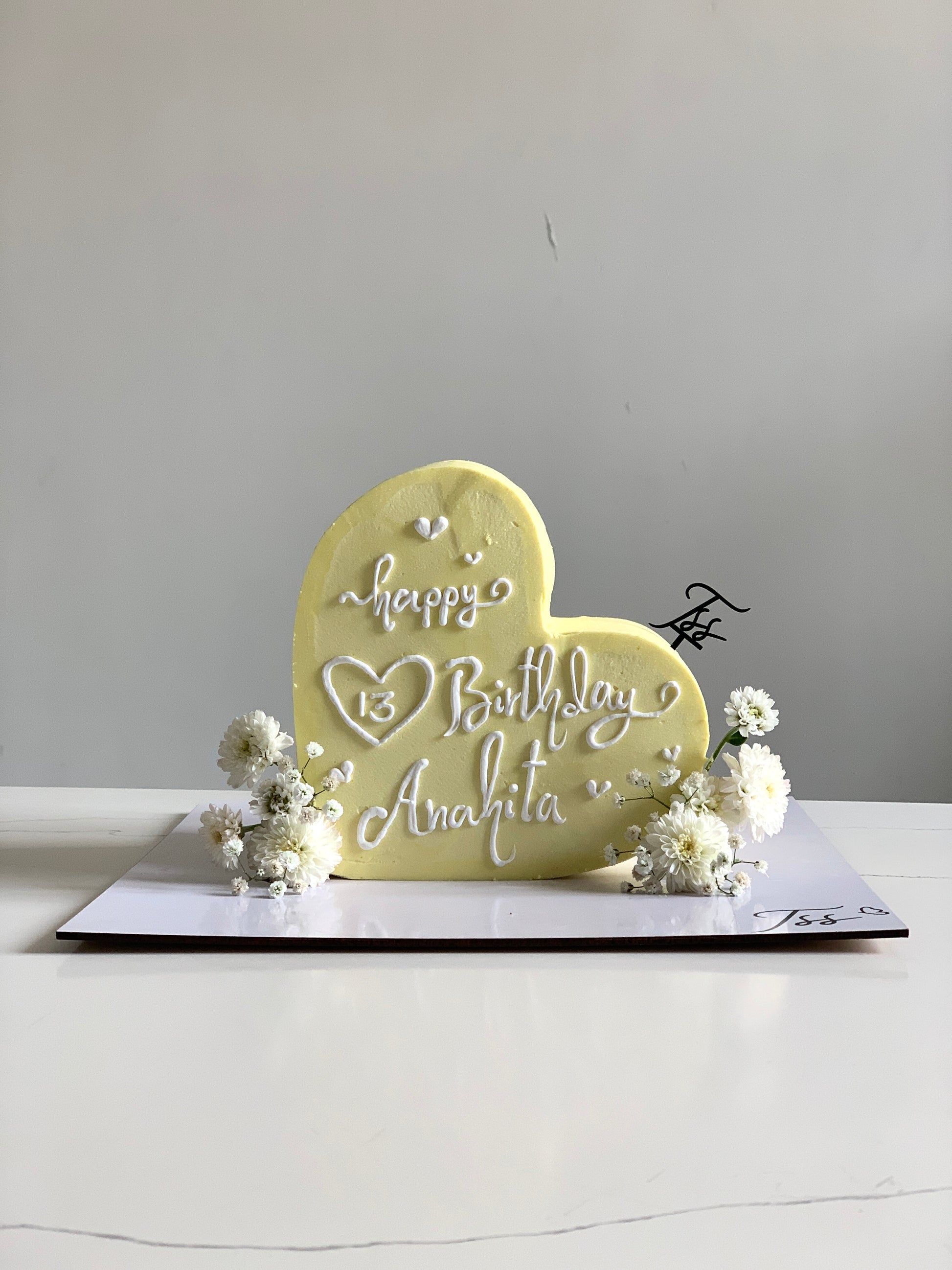 Heart-shaped cakes from The Sinful Spoon, decorated with pink icing and sprinkles, perfect for special occasions.