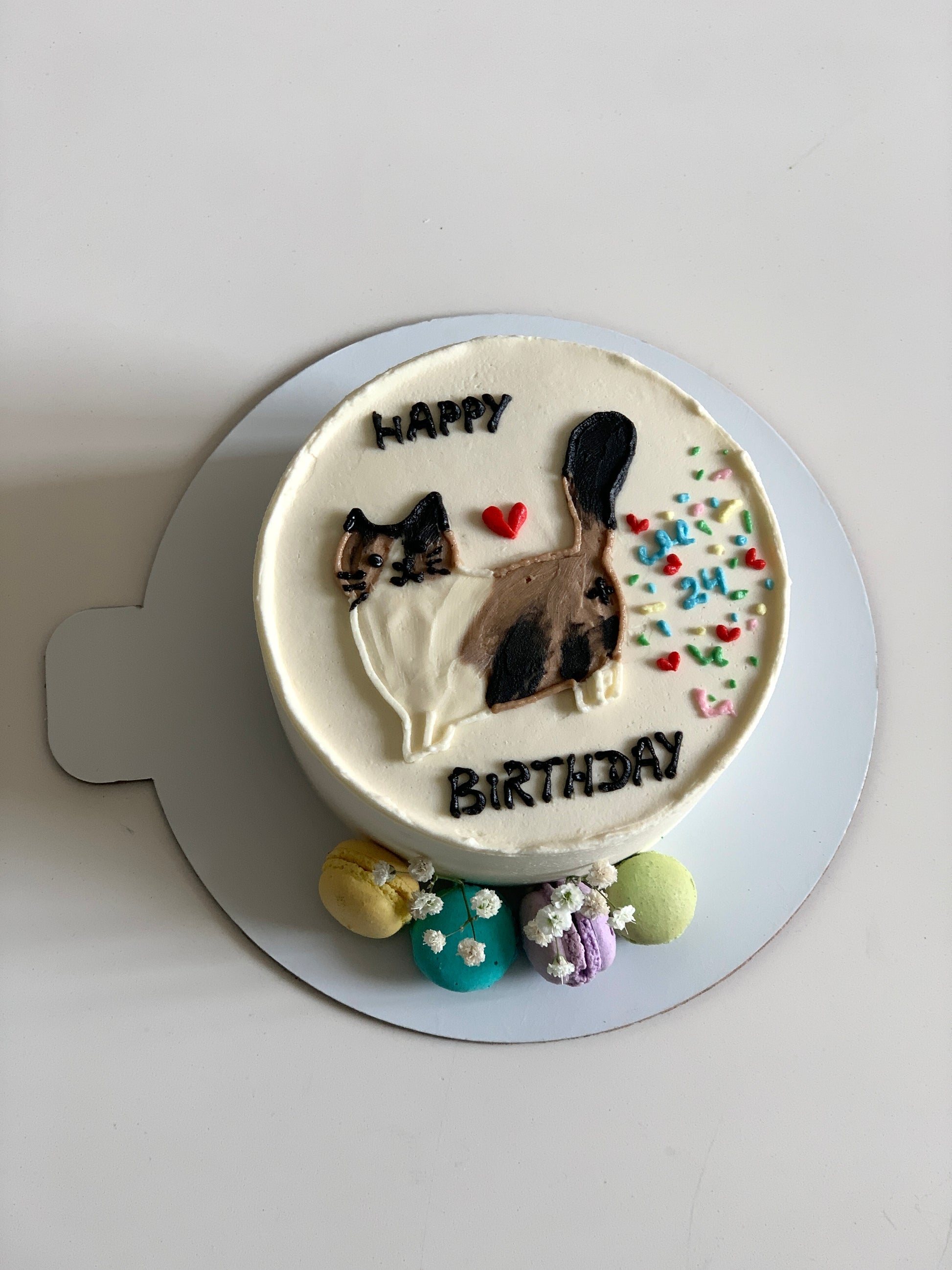 Colorful buttercream illustration cake by The Sinful Spoon featuring vibrant floral and whimsical design on smooth cake surface.