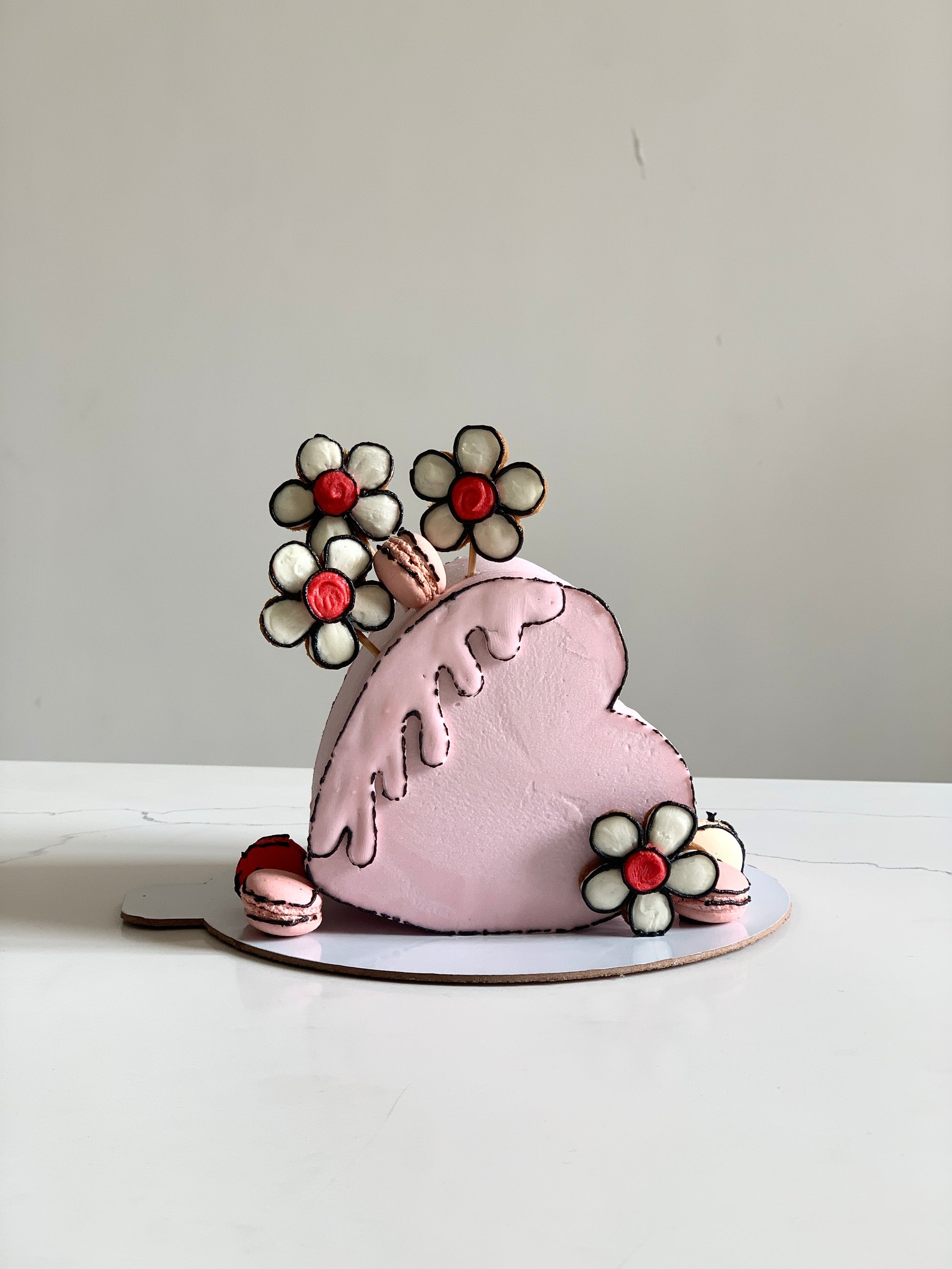 Heart shaped cakes from The Sinful Spoon displayed on a plate with decorative toppings and a romantic setting.
