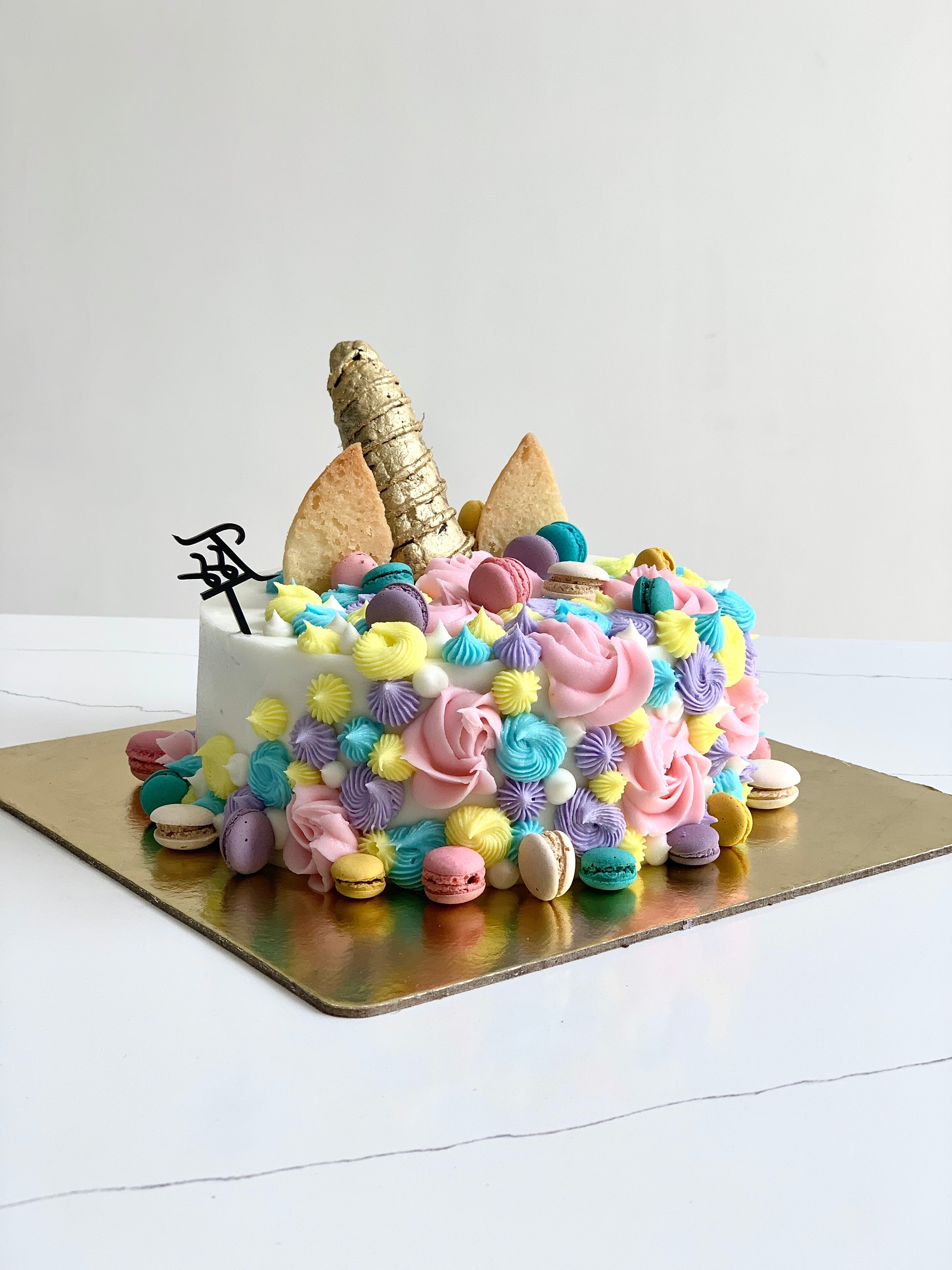 Decorative shape cakes by The Sinful Spoon featuring colorful, artistic designs on intricately shaped cake surfaces.