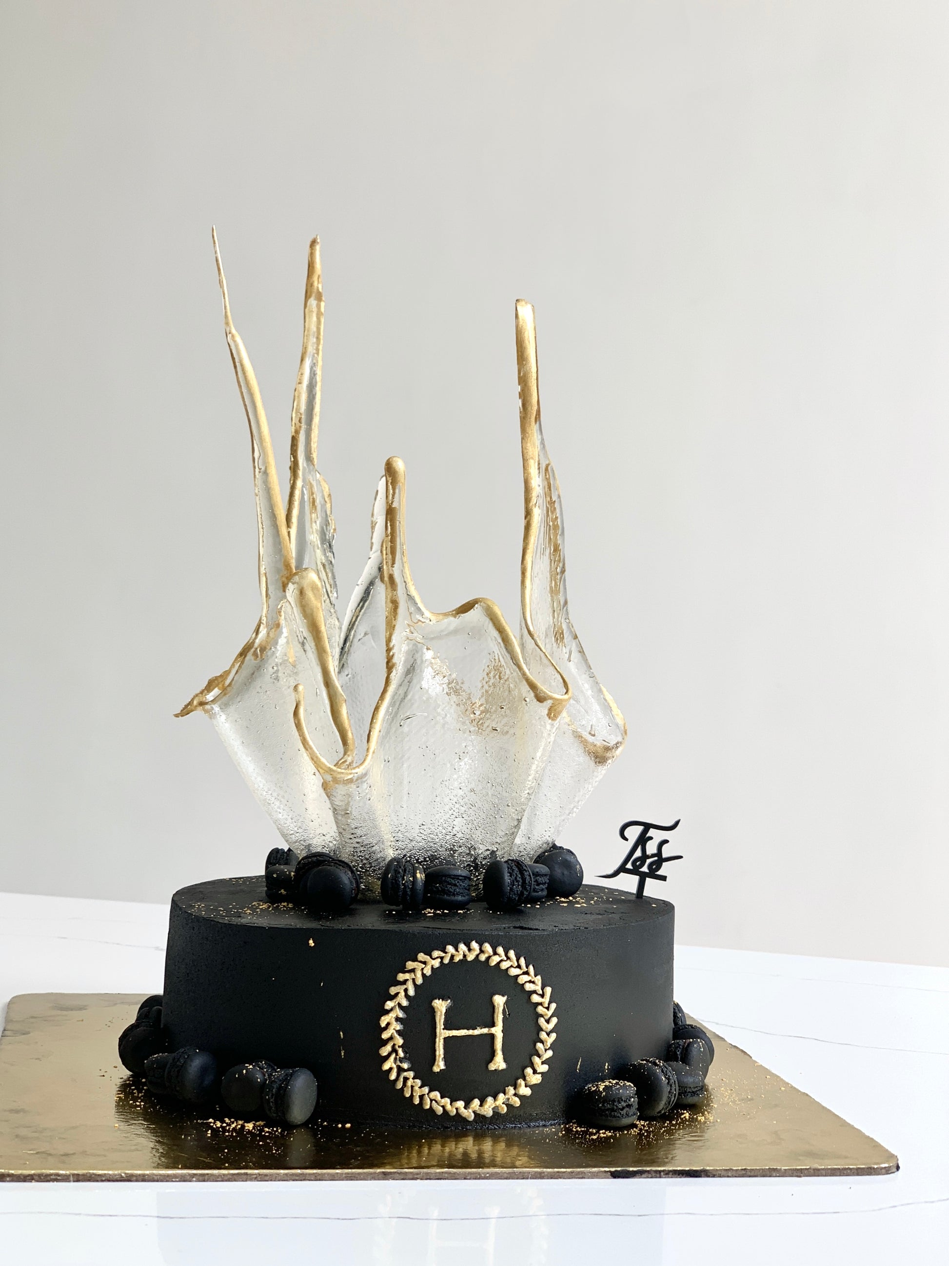 Colorful isomalt cakes by The Sinful Spoon, vibrant and glossy sugar decorations for baking and cake decorating.