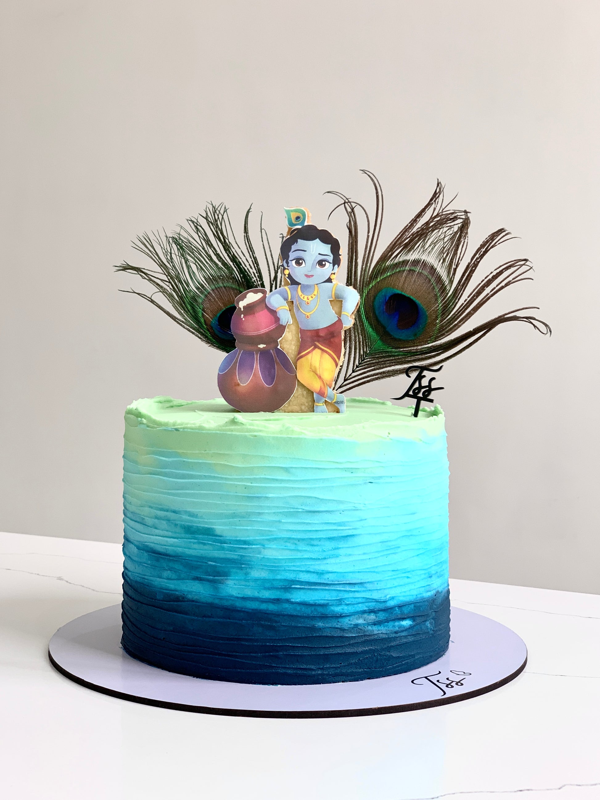 Decorative festive cakes from The Sinful Spoon with colorful icing and holiday-themed designs on a platter.