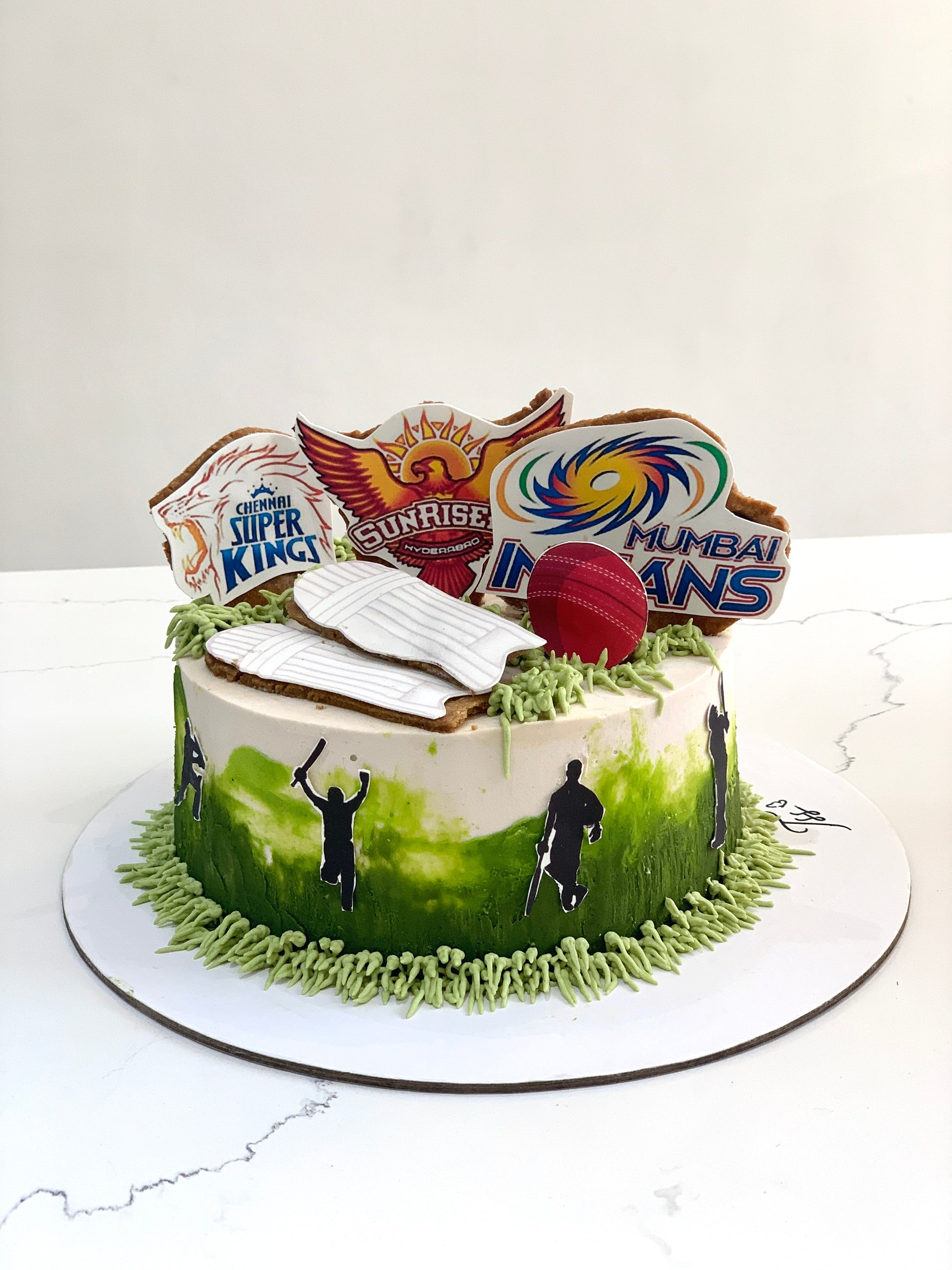 Decorative edible paper cake topper for a baby boy, featuring colorful designs, from The Sinful Spoon.