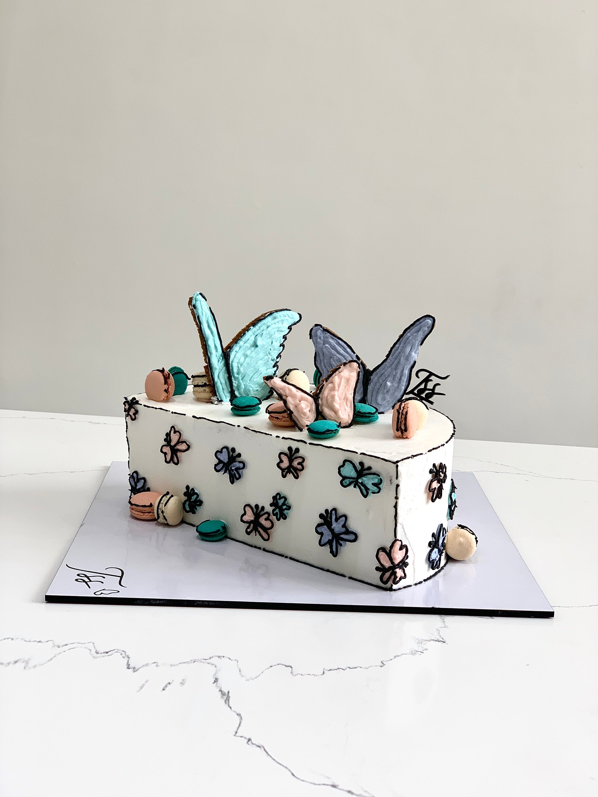 Decorative half birthday cake from The Sinful Spoon with colorful frosting and birthday candles, perfect for celebrating milestone moments.