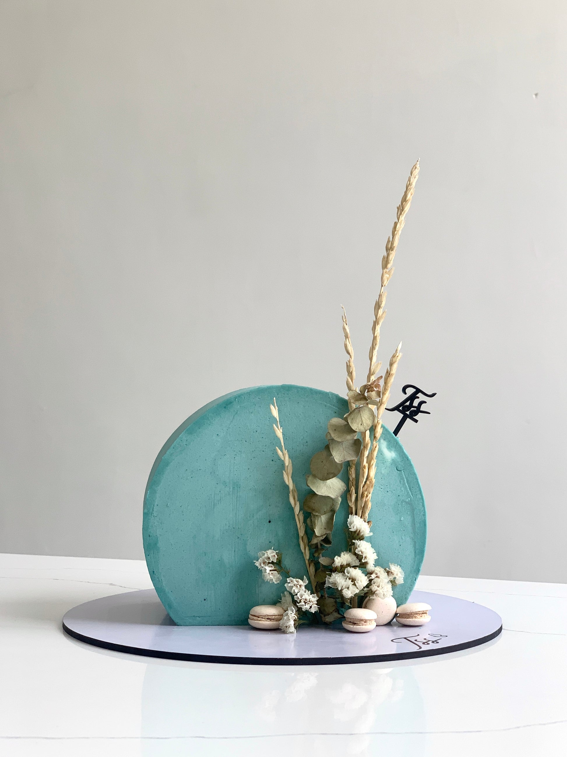 Fresh floral cakes by The Sinful Spoon with colorful edible flowers and detailed cake decorations on a white background.