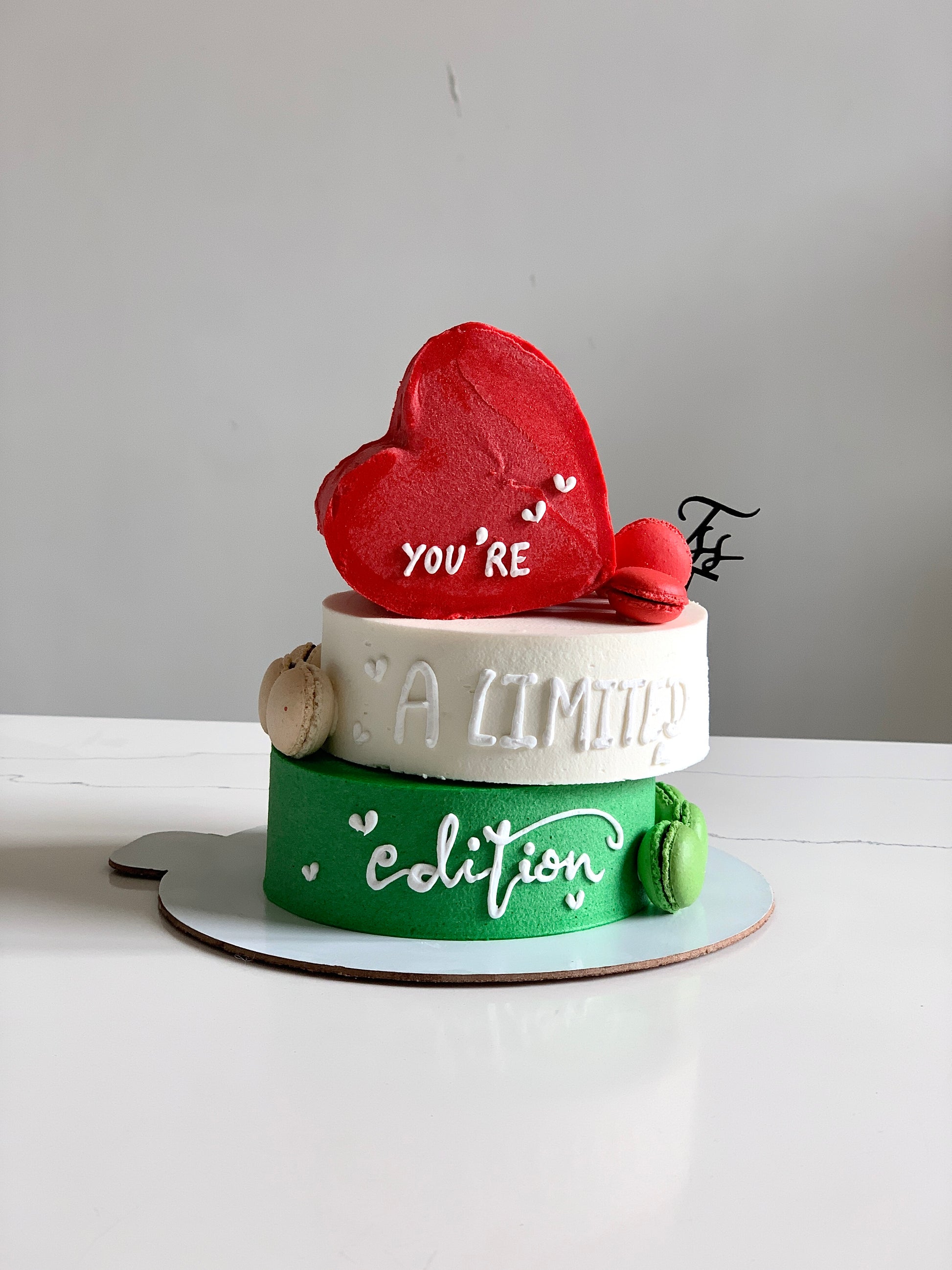 Heart-shaped cakes from The Sinful Spoon, decorated with pink icing and floral accents, displayed on a white plate.
