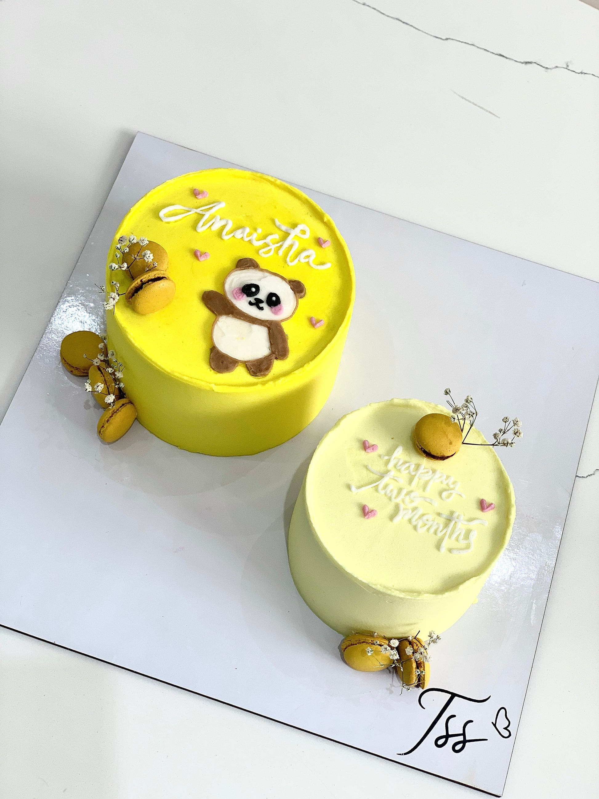 Assorted combo cakes from The Sinful Spoon with colorful frosting and decorative toppings on a white plate.