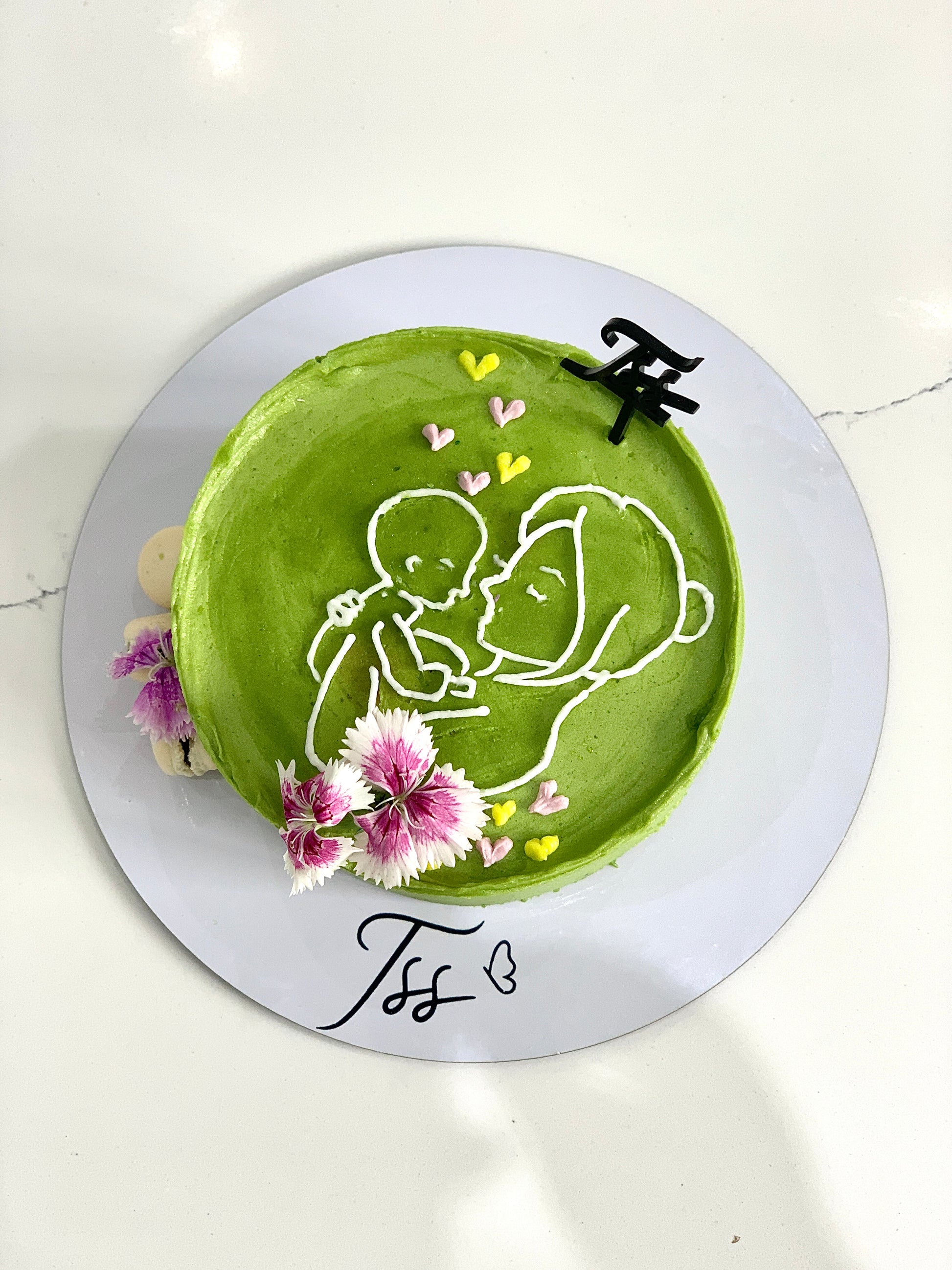 Decorative Mother's Day cake from The Sinful Spoon with floral icing and festive design, perfect for celebrating moms.