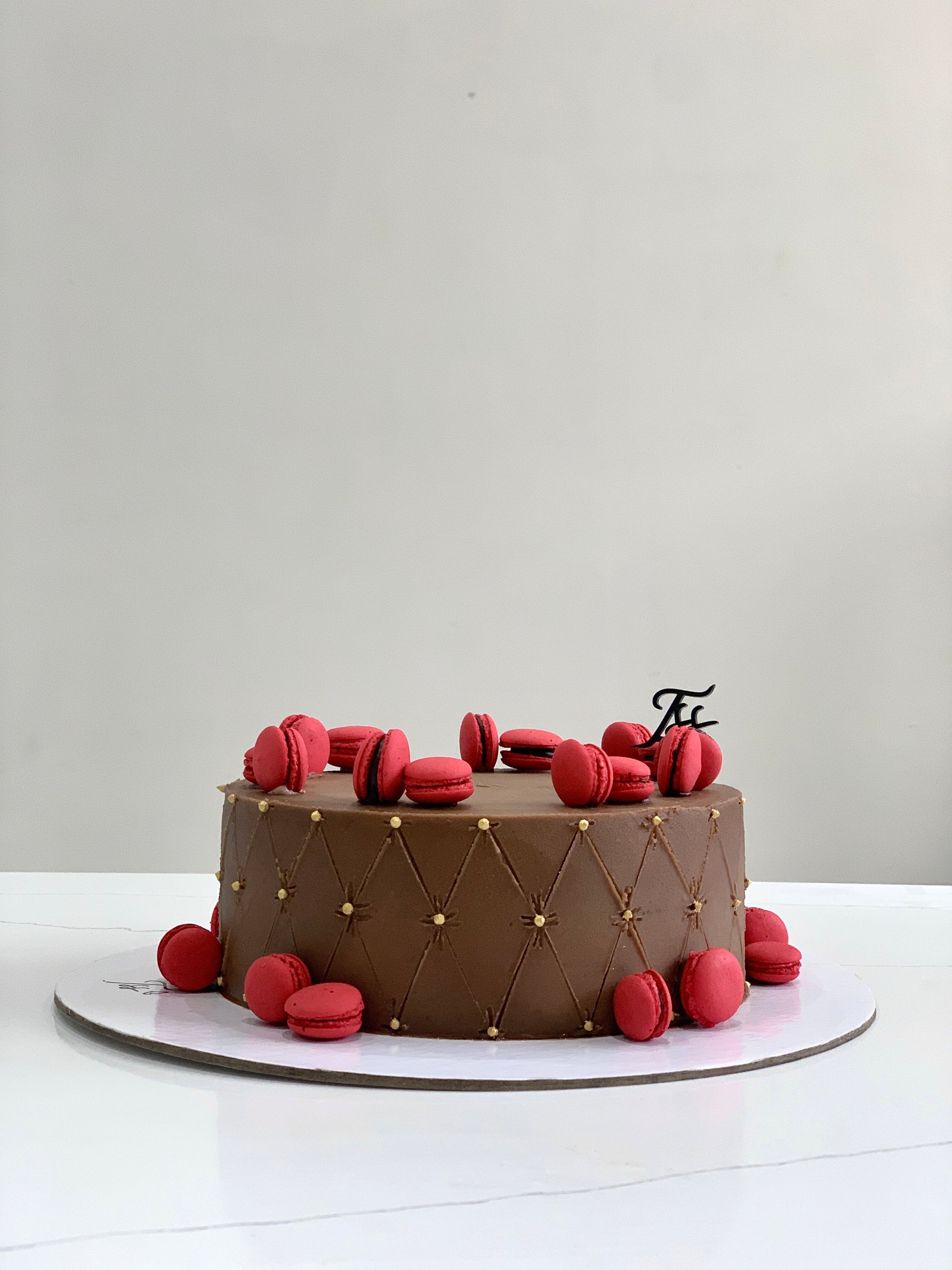 Classic Cakes by The Sinful Spoon, showing a variety of freshly baked layered cakes with decorative frosting and colorful toppings.