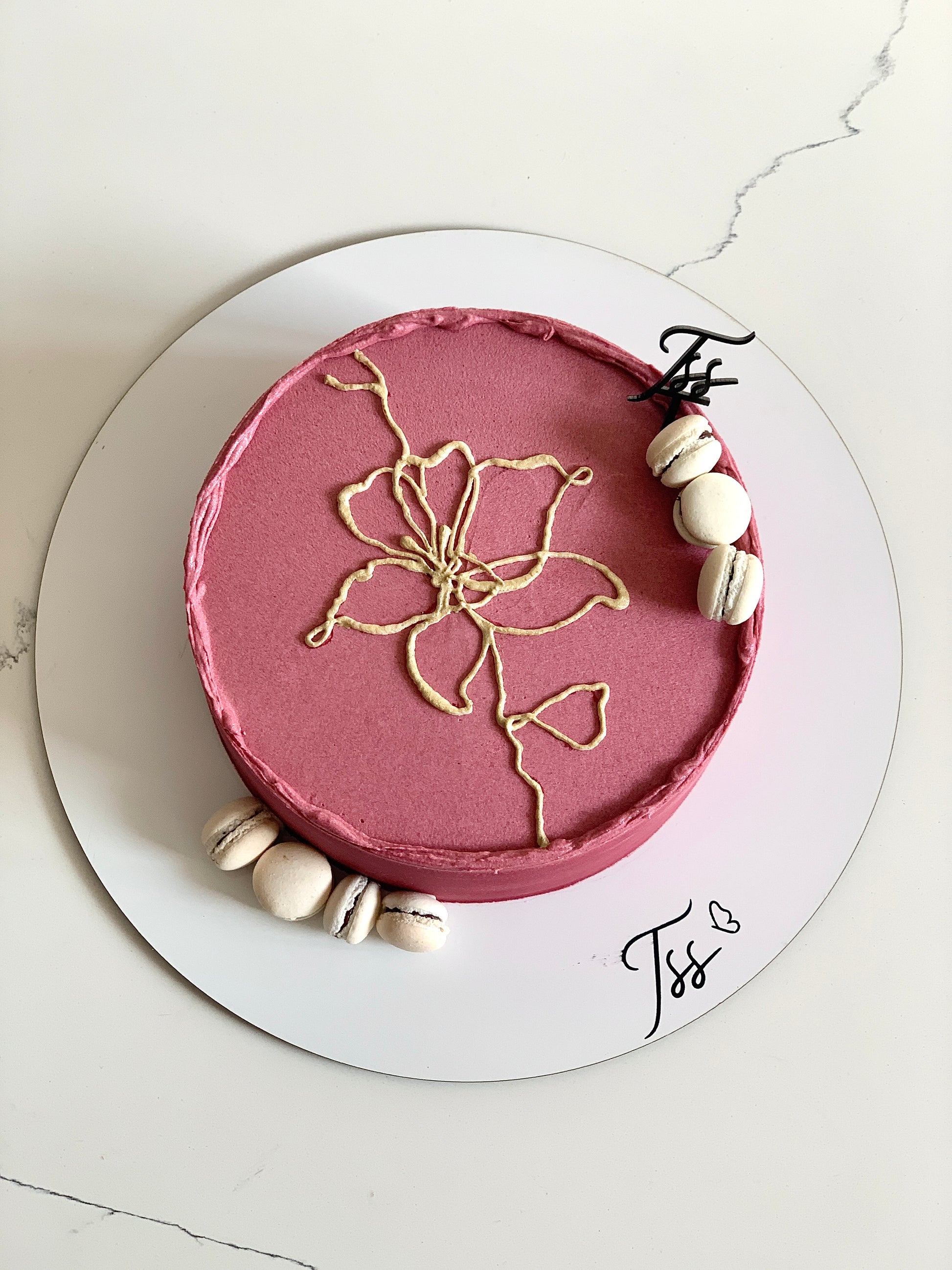 Decorative buttercream illustration cake by The Sinful Spoon with colorful floral and artistic piping details.