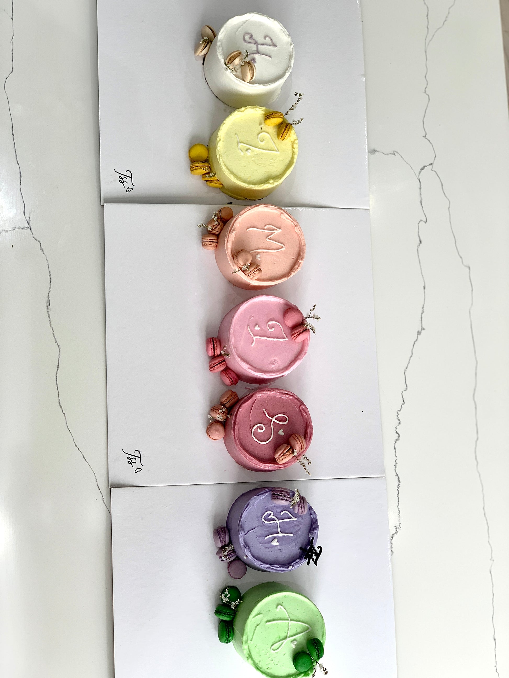 Colorful bento cakes from The Sinful Spoon, featuring layered designs and vibrant frosting in a close-up shot.