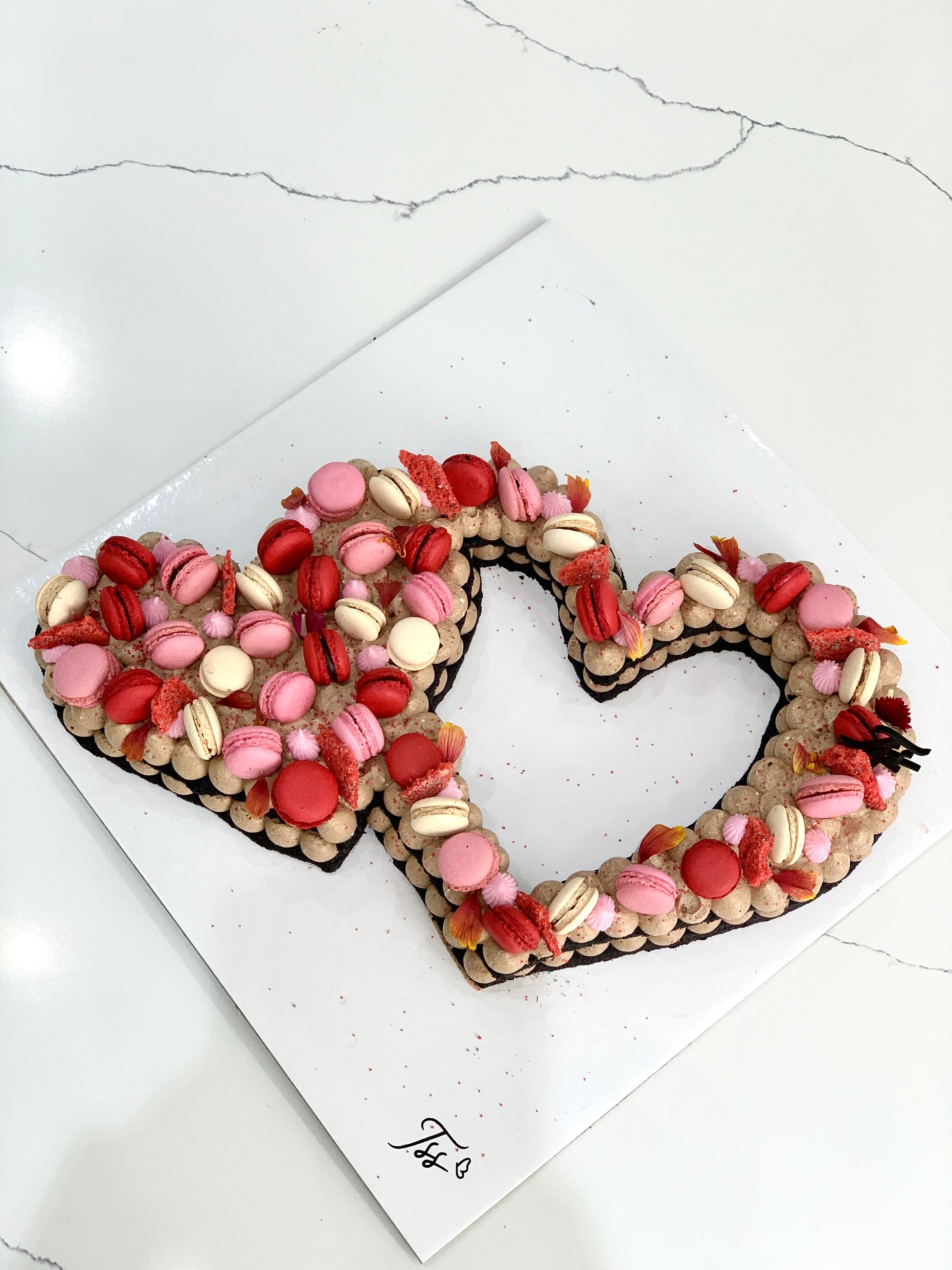Chocolate chip cookie cake from The Sinful Spoon with a thick, soft texture and decorative frosting on top.