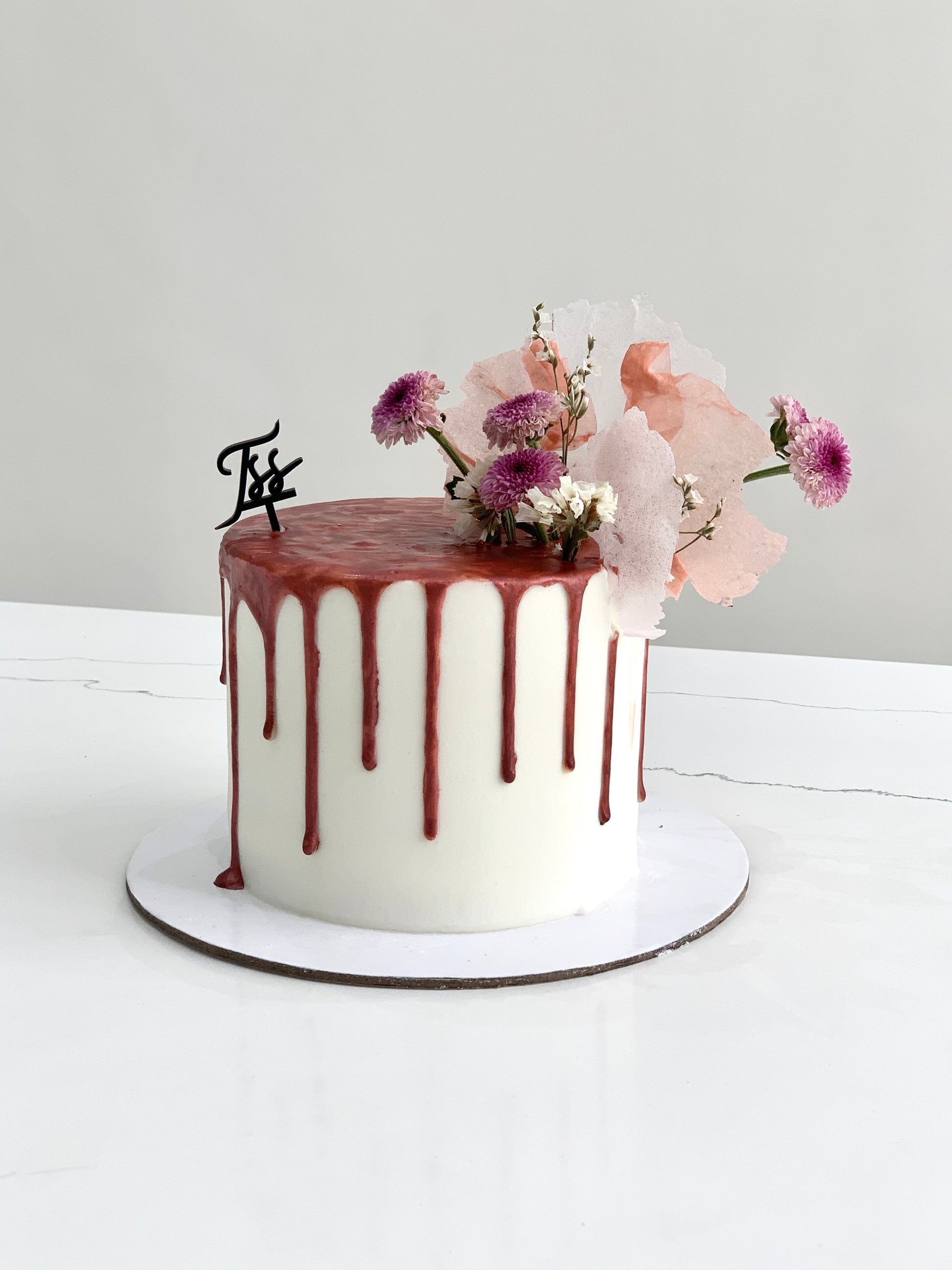 Fresh floral cakes from The Sinful Spoon with colorful icing and decorative edible flowers, perfect for special celebrations.