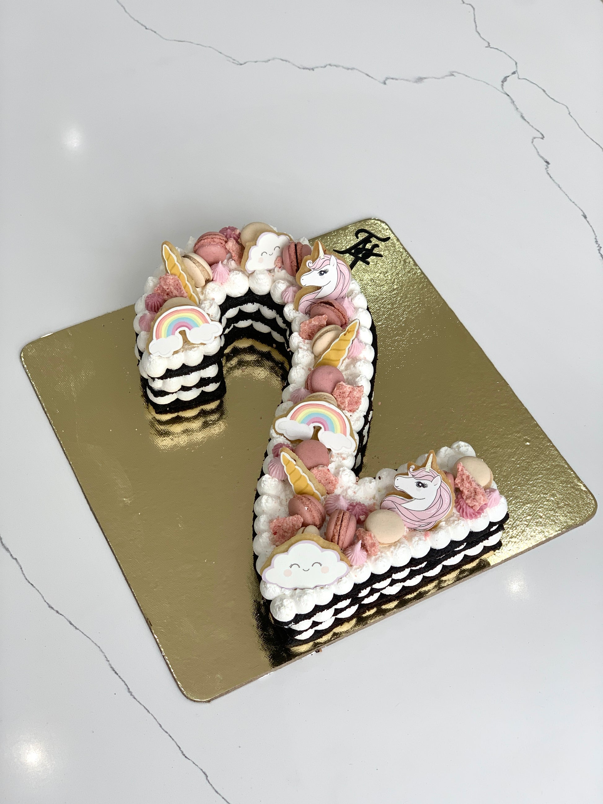 Chocolate chip cookie cake from The Sinful Spoon with colorful sprinkles and a festive decoration on top.