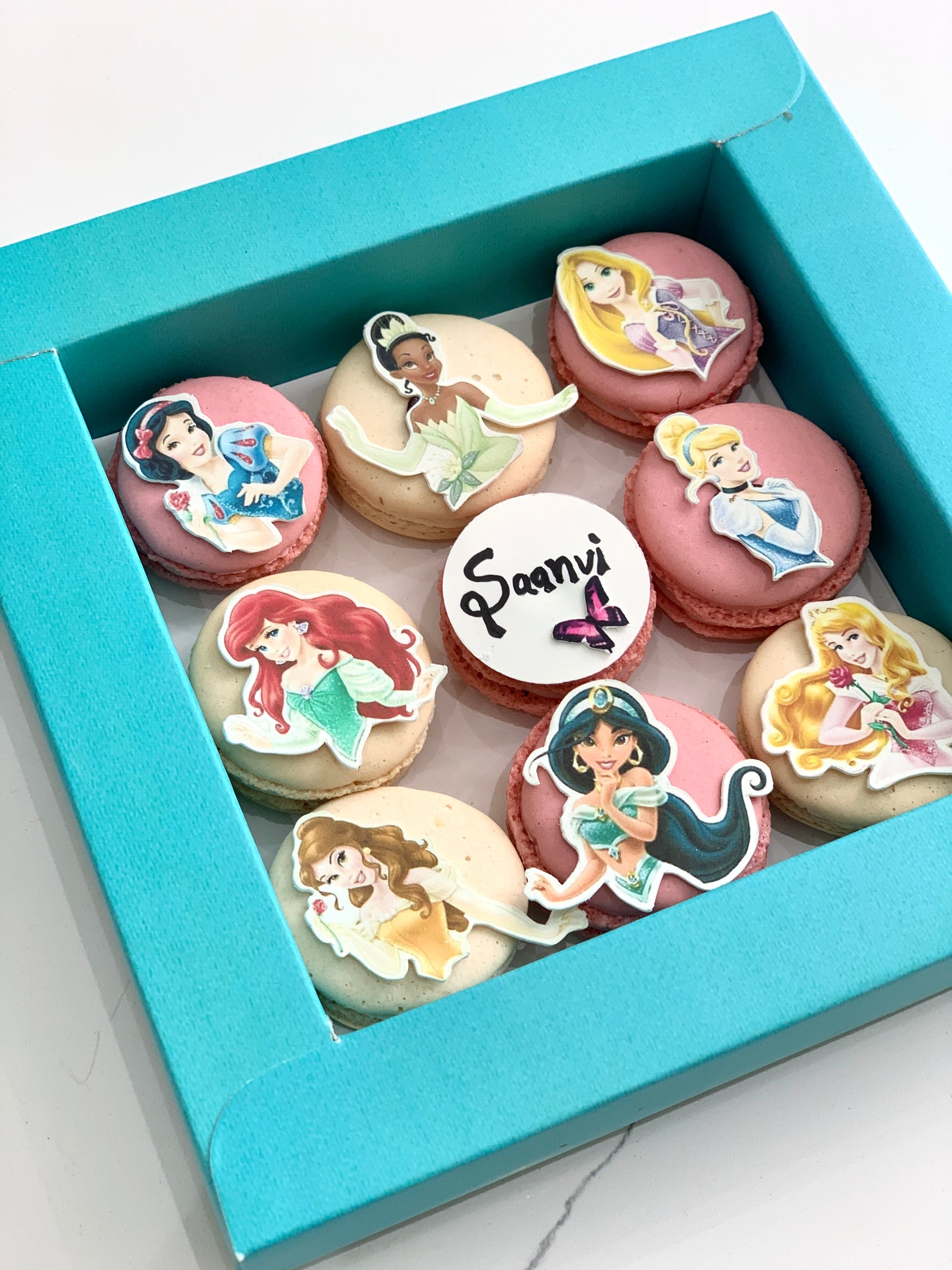 Colorful cupcakes with swirled frosting and sprinkles on a plate, created by The Sinful Spoon.