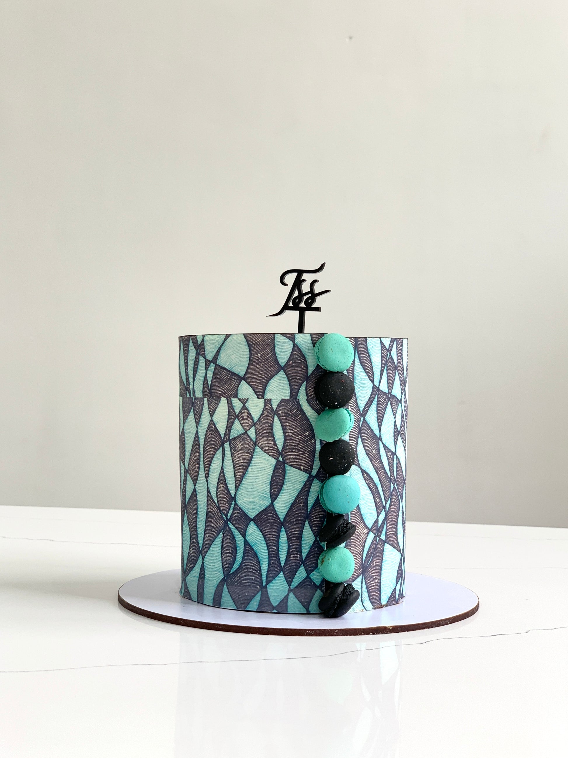 Edible paper cake decoration from The Sinful Spoon, close-up of colorful, intricate edible paper designs on a cake.