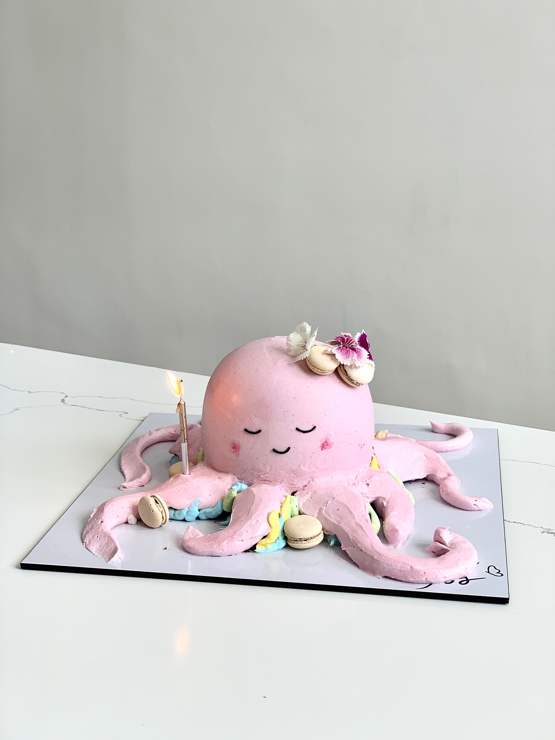Colorful shaped cakes from The Sinful Spoon, decorated with vibrant icing and intricate designs, perfect for celebrations.