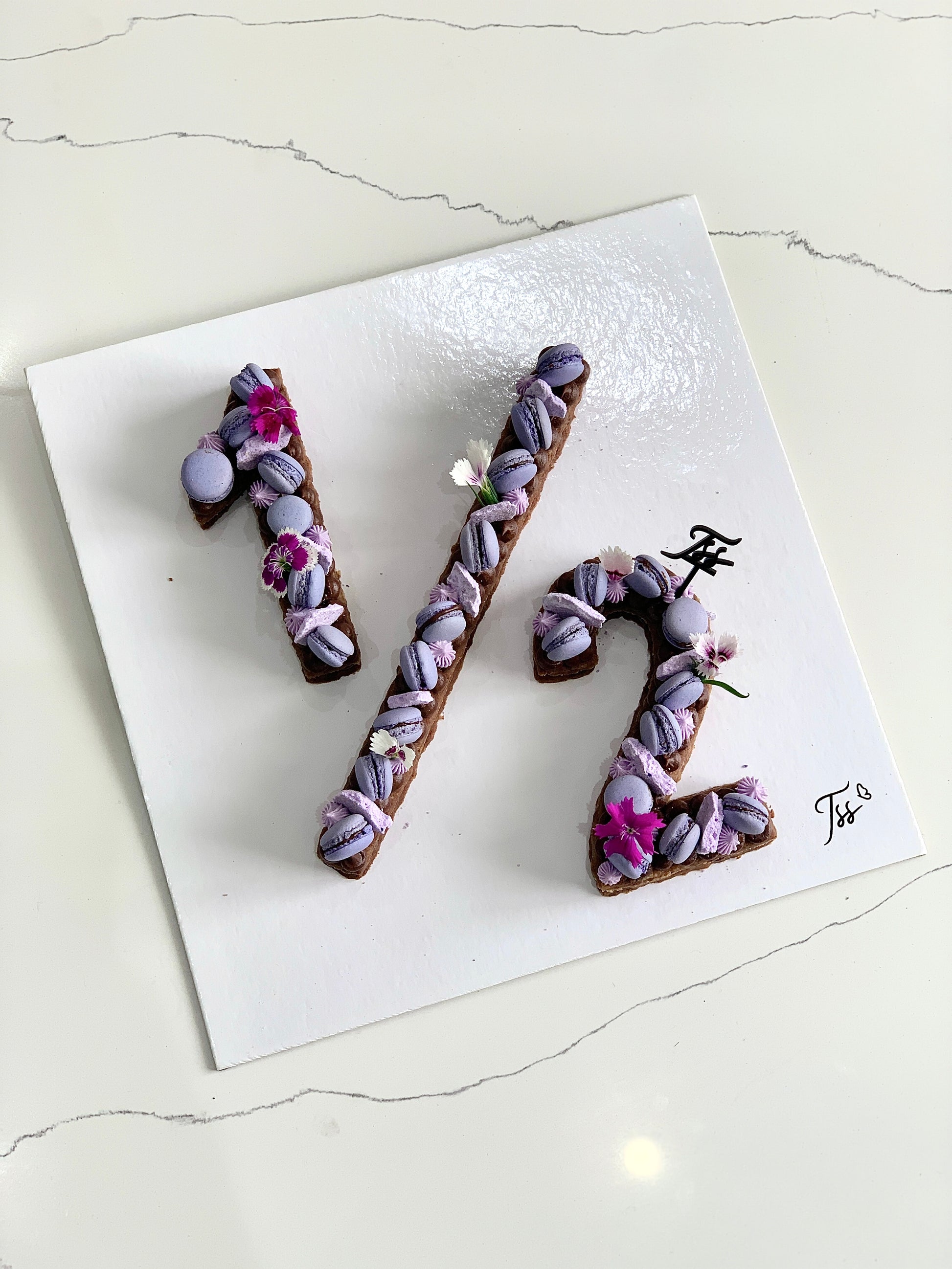 Colorful half birthday cake from The Sinful Spoon with festive decorations and layered frosting, perfect for celebrating milestone moments.