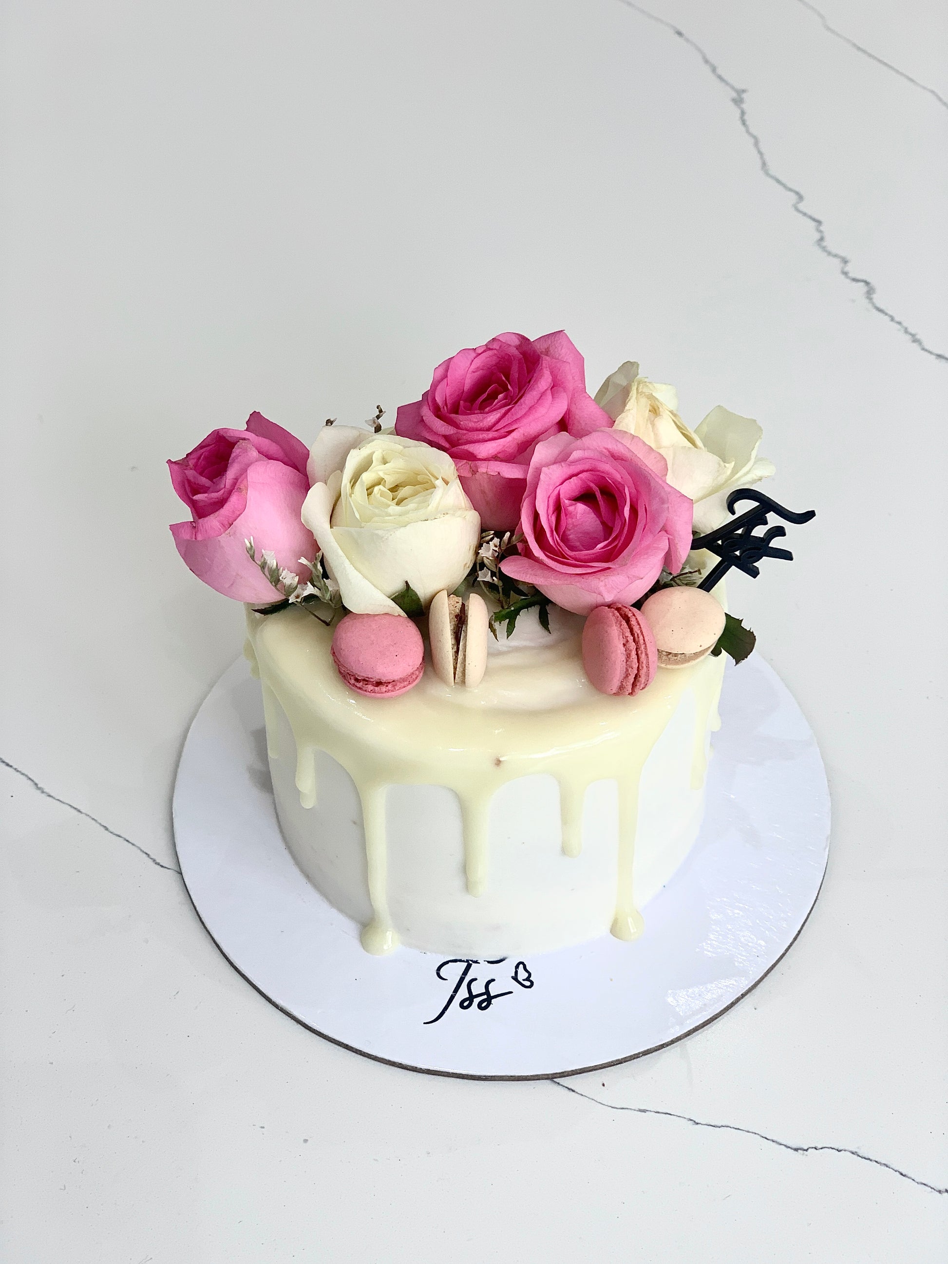Fresh floral cakes from The Sinful Spoon featuring colorful, beautifully decorated cakes with edible flowers and intricate designs.