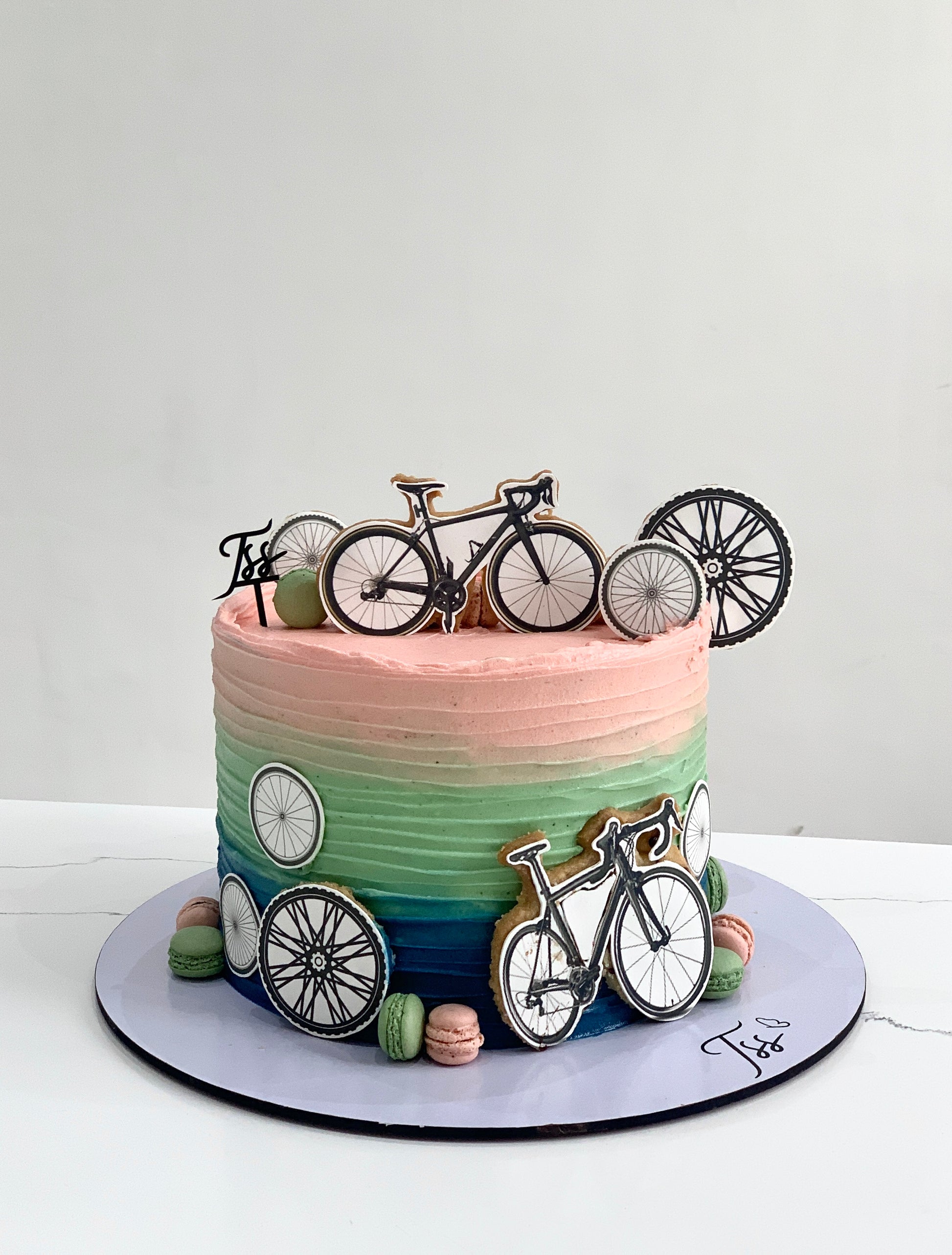 Edible paper cakes by The Sinful Spoon featuring colorful decorative designs on layered cake slices.