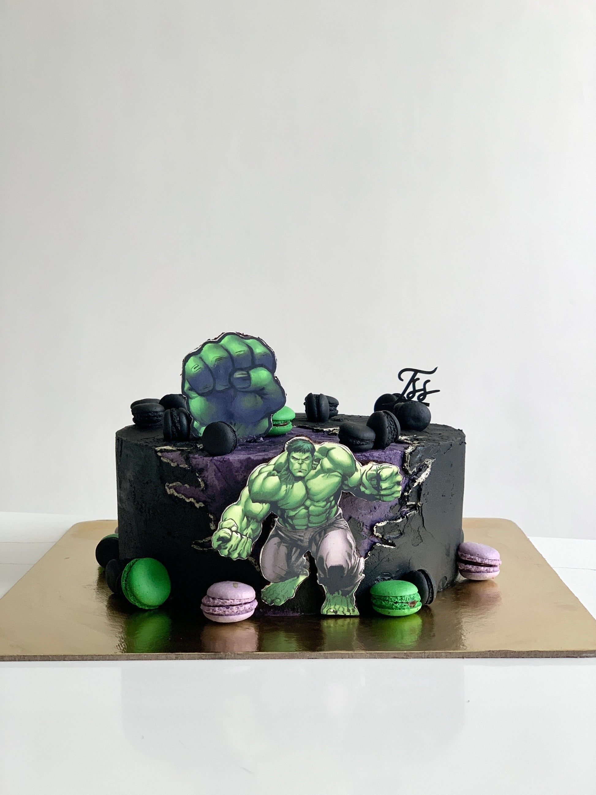 Edible paper cake decorated for a baby boy celebration, featuring colorful baby-themed designs on a smooth cake surface.